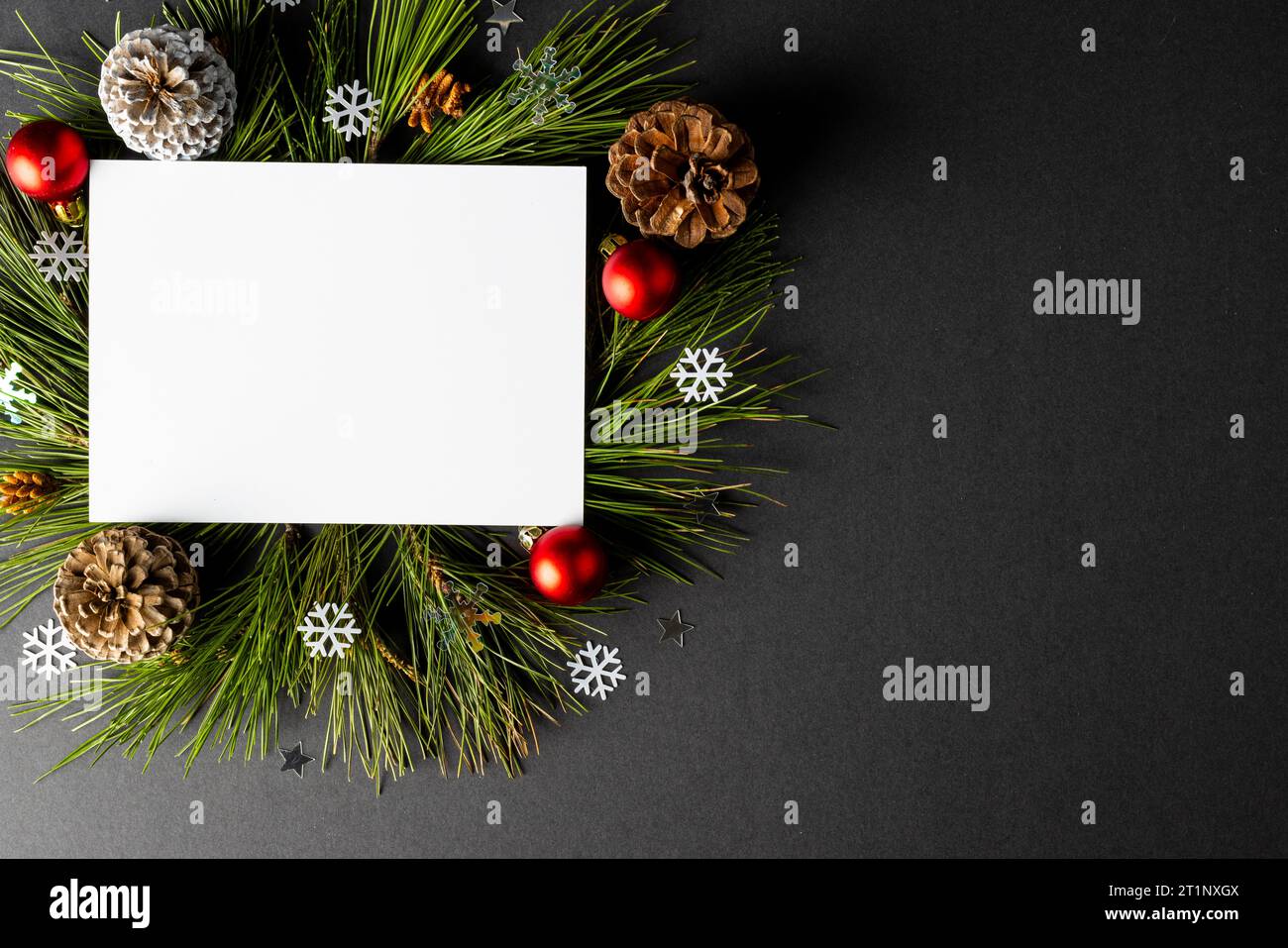 Christmas decorations with white card and copy space on black ...