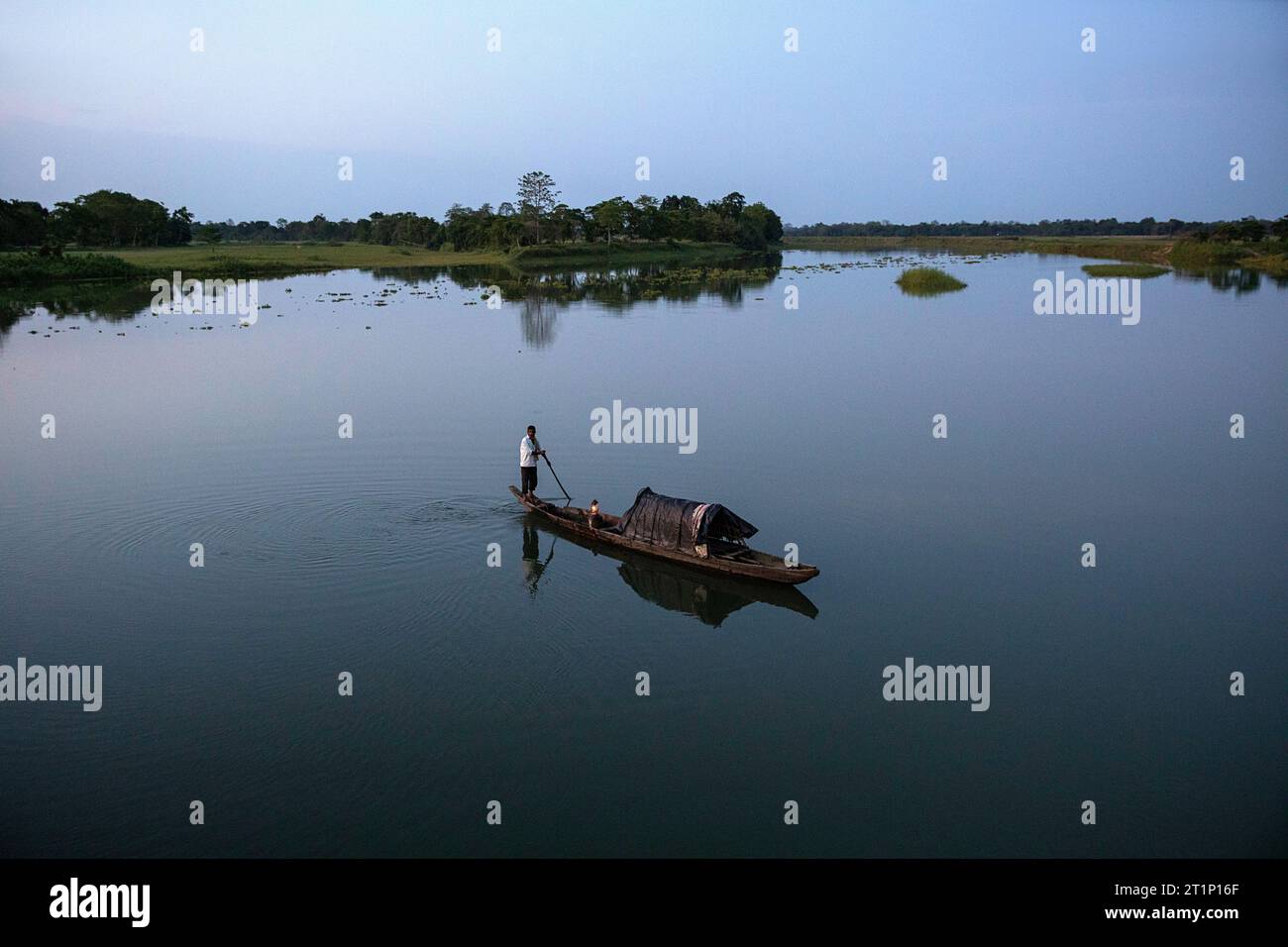 A local fisherman on back of a fishing dugout canoe with light and