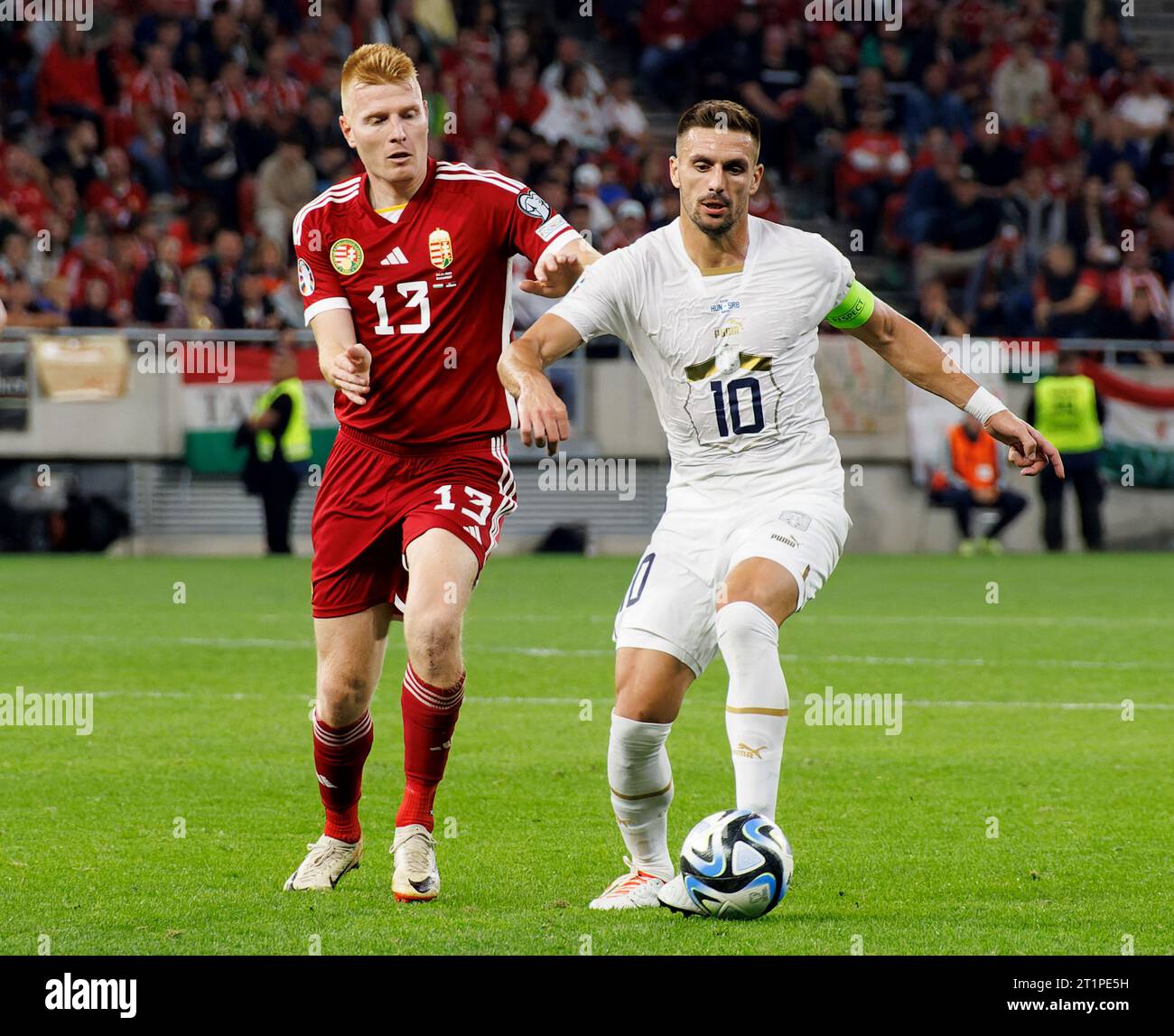 Budapest, Hungary. 14st October, 2023. Zsolt Kalmar of Hungary challenges Dusan Tadic of Serbia during the UEFA EURO 2024 European qualifier match between Hungary and Serbia at Puskas Arena on October 14, 2023 in Budapest, Hungary. Credit: Laszlo Szirtesi/Alamy Live News Stock Photo