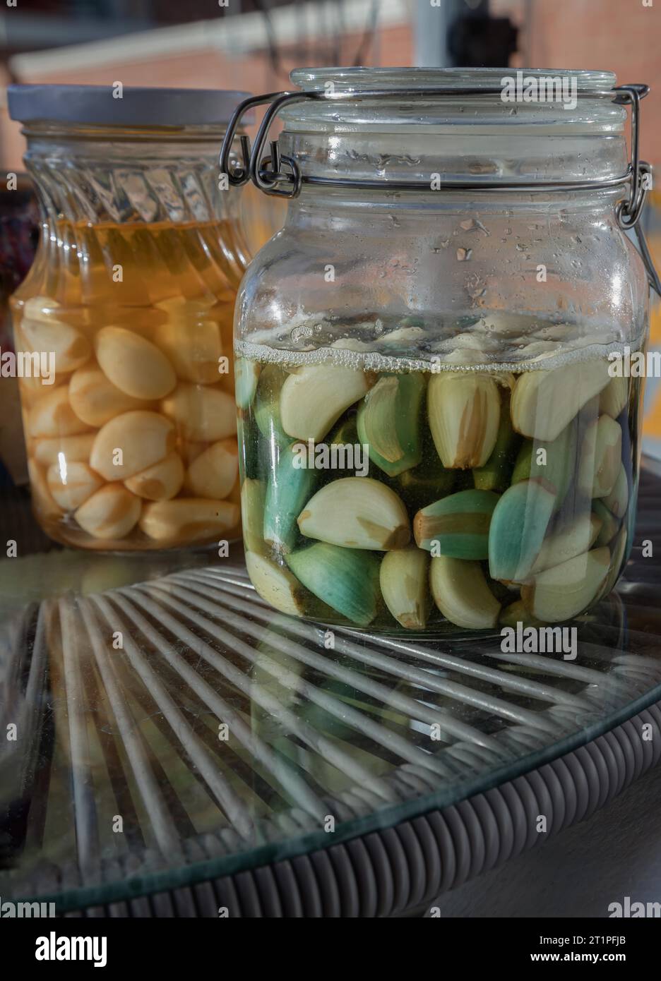 Glass jars with Garlic pickled in Apple cider vinegar with Rock sugar