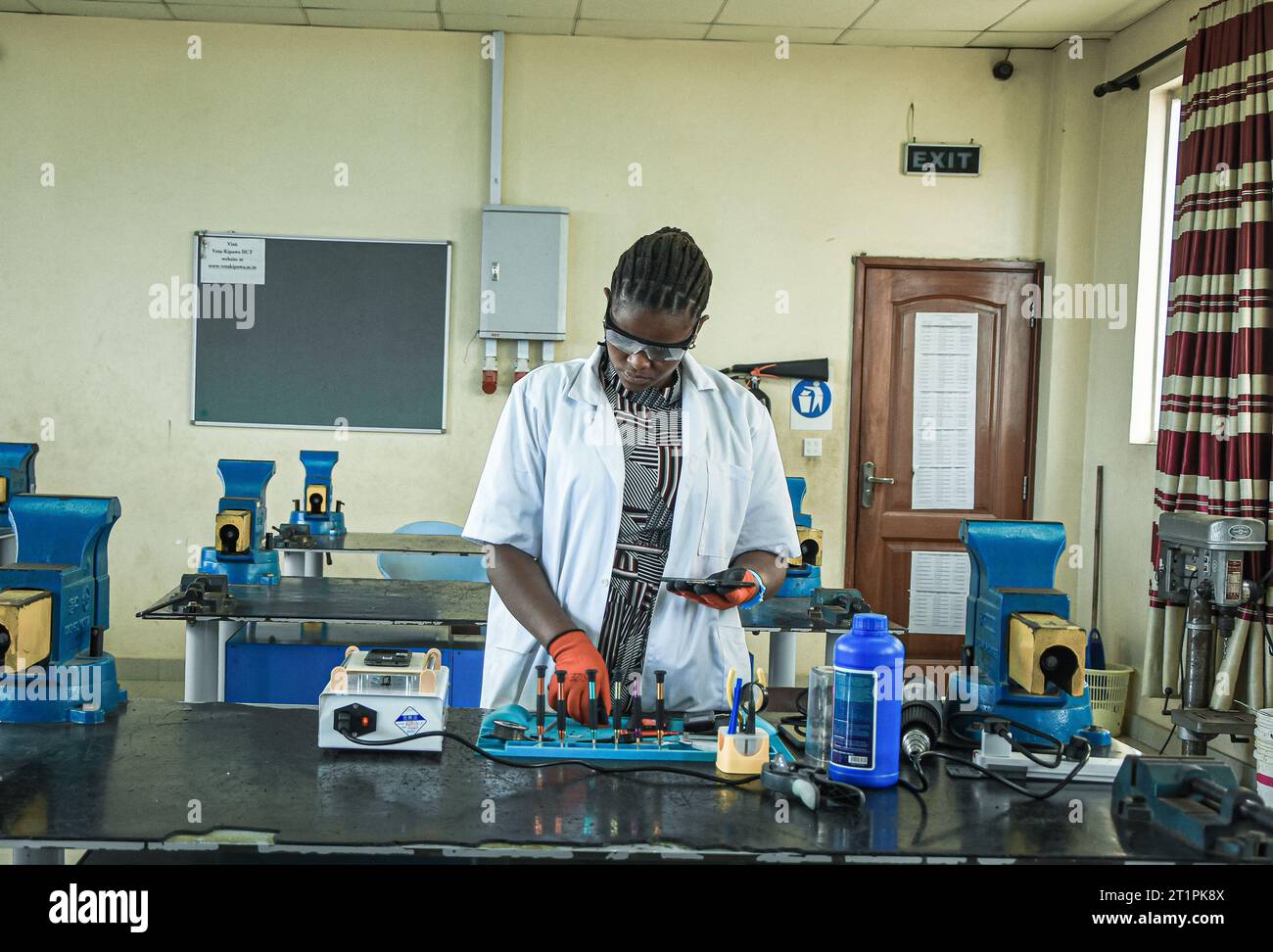 Female technician at the Vocational training centre repairing a mobile