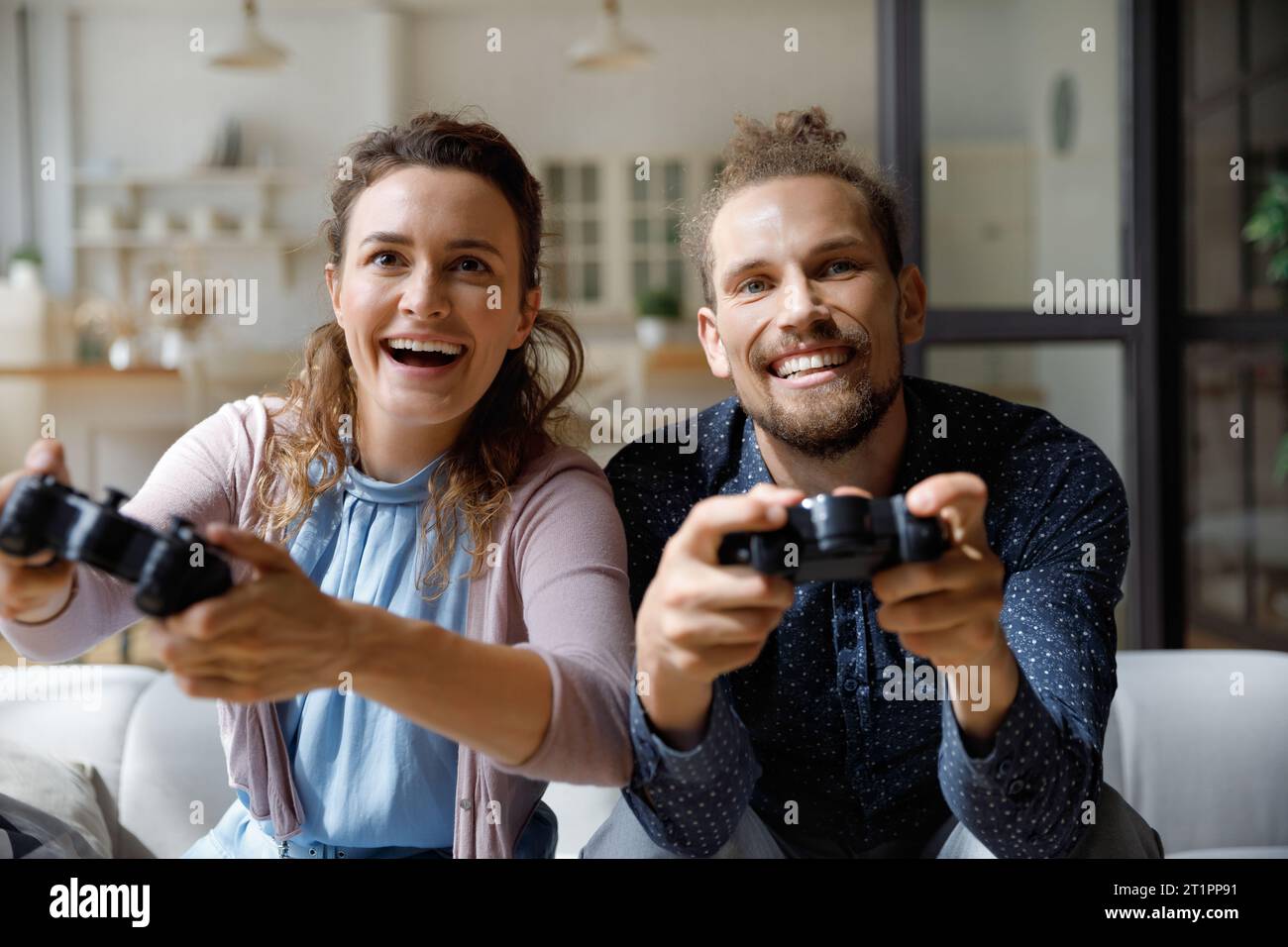 Amazed happy young couple having fun at home Stock Photo