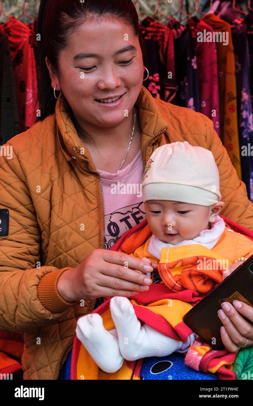 Can Cau Market Scene, Vietnam. Hmong Mother and Child. Lao Cai Province. Stock Photo