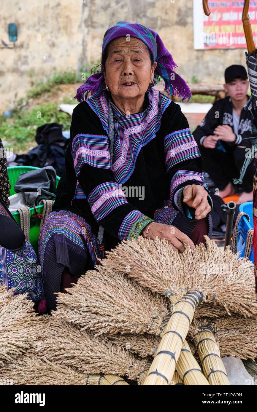 Can Cau Market Scene, Vietnam. Hmong Woman Selling Brooms. Lao Cai Province. Stock Photo