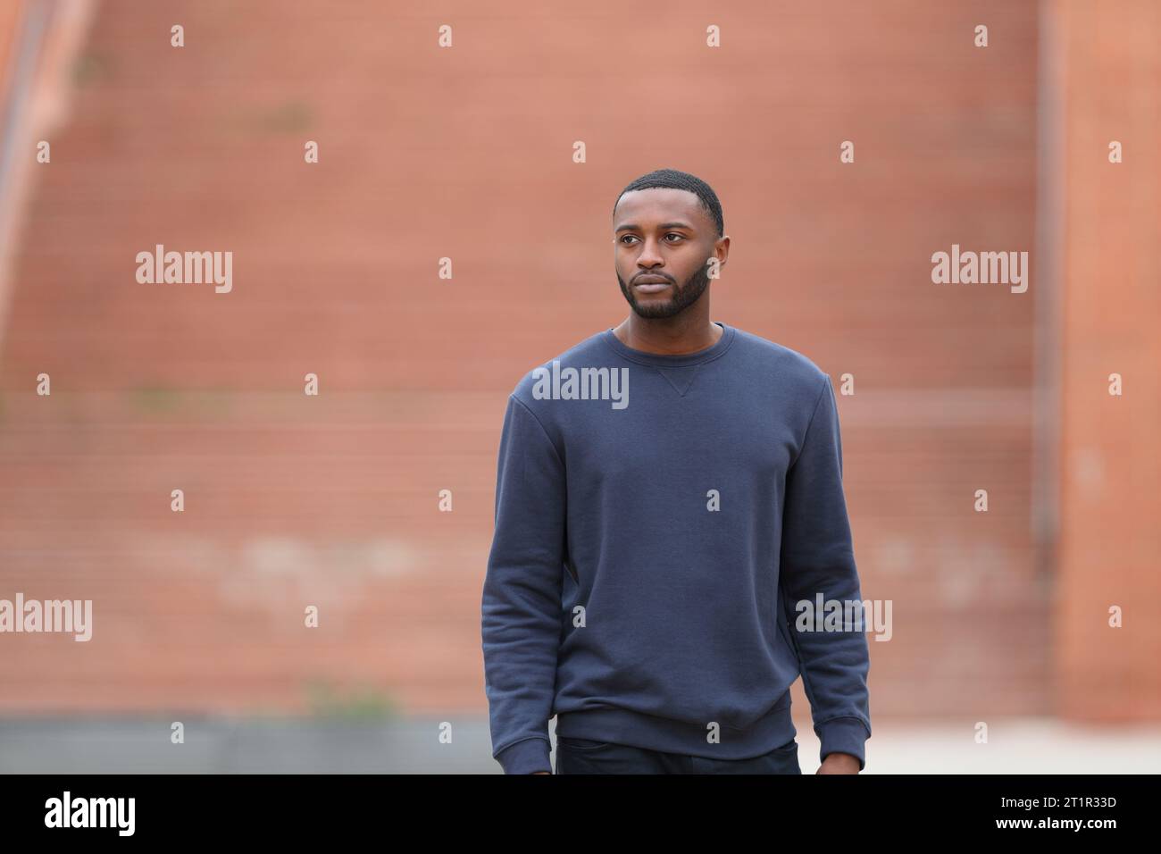 Front view portrait of a black man walking in a park Stock Photo - Alamy