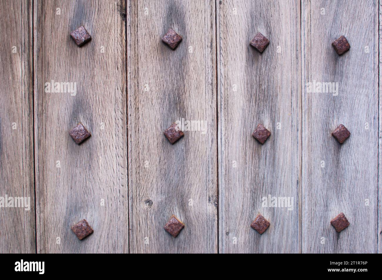 Ancient door with iron rivets - John Gollop Stock Photo