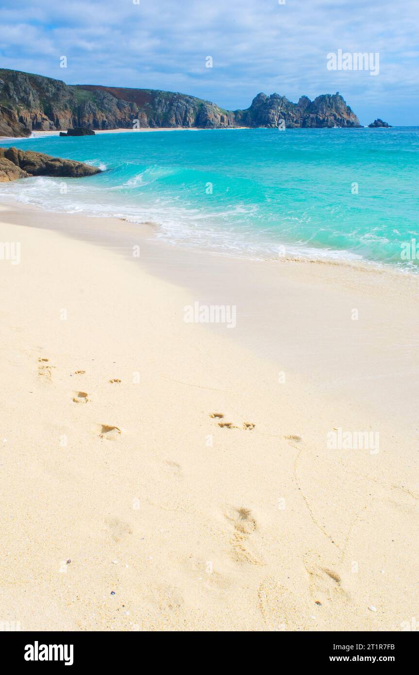 Footprints on a deserted beach, Porthcurno, Cornwall, UK - John Gollop Stock Photo
