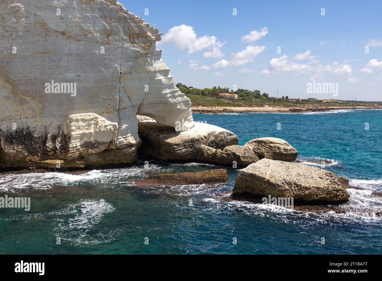 White cliff and rocks immersing the sea at Rosh Hanikra, North Israel ...