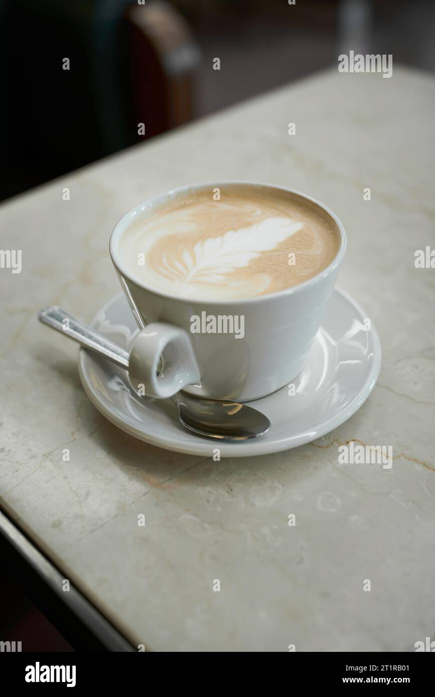 A cup of latte macchiato on a table in a cafe in the old town of Prague Stock Photo