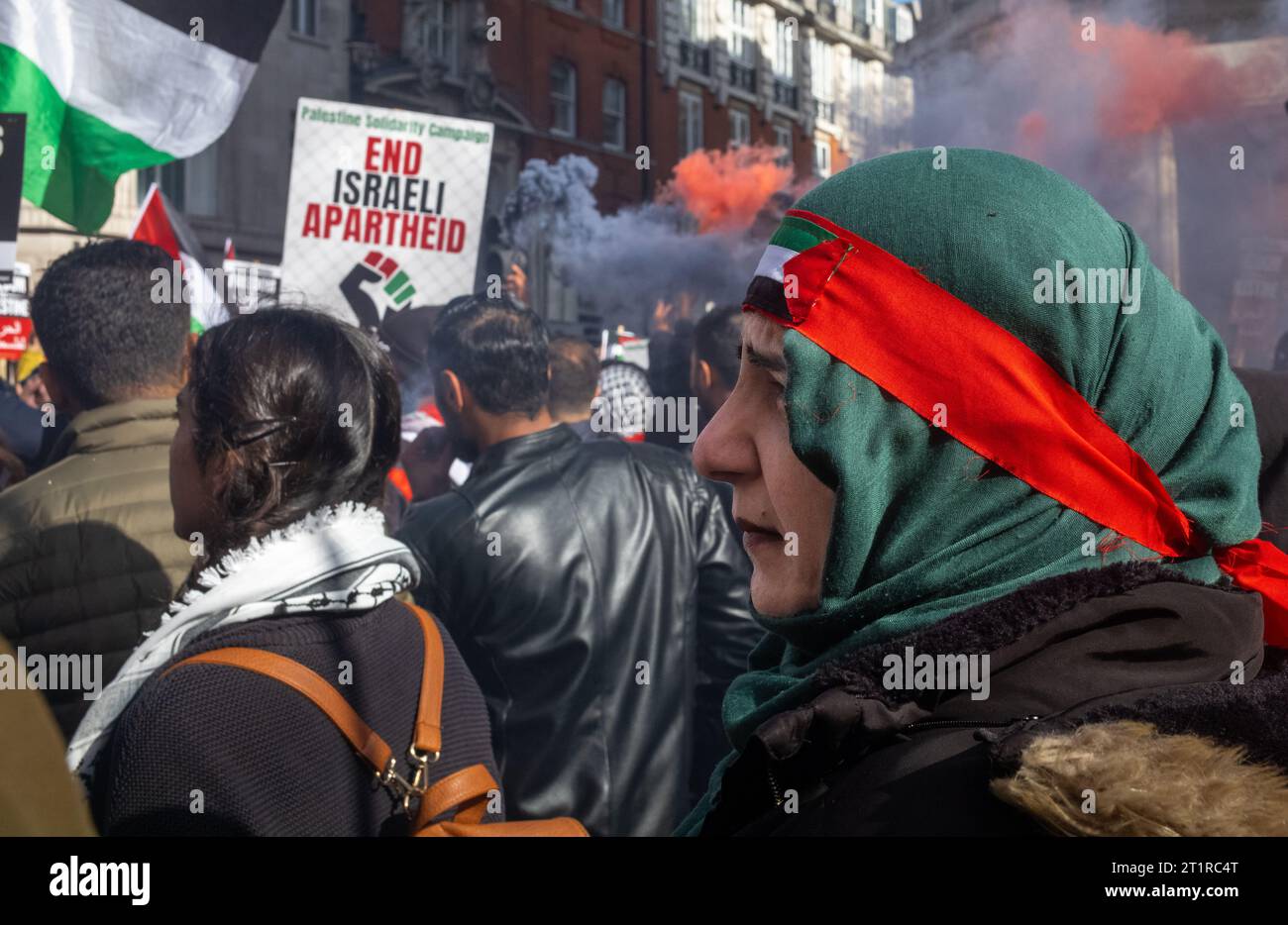 London, UK. 14 Oct 2023: Pro-Palestinian protesters march with placards and flares in central London, UK at a demonstration against Israeli attacks on Stock Photo