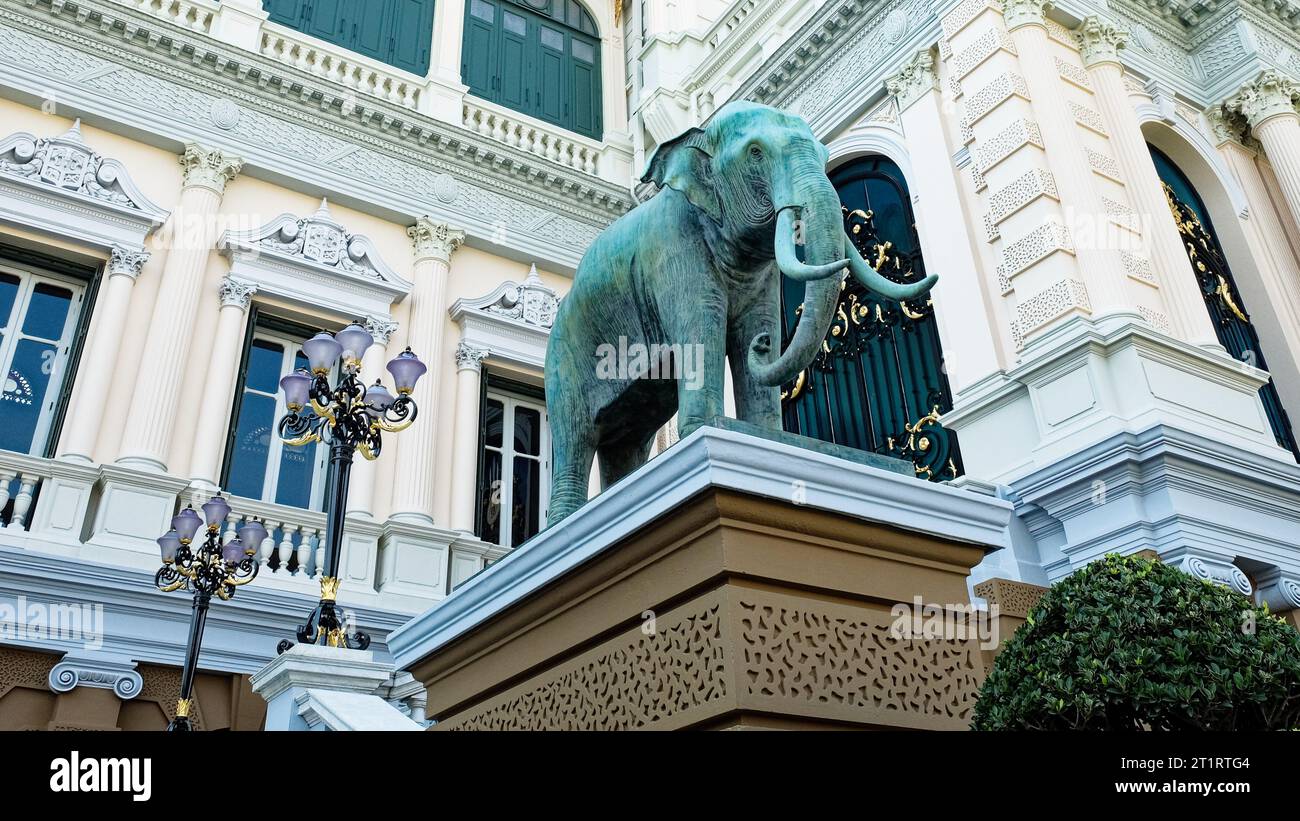 The focal point is a massive elephant statue, perched on a pedestal adorned with elaborate patterns, set against the backdrop of an opulently accented Stock Photo