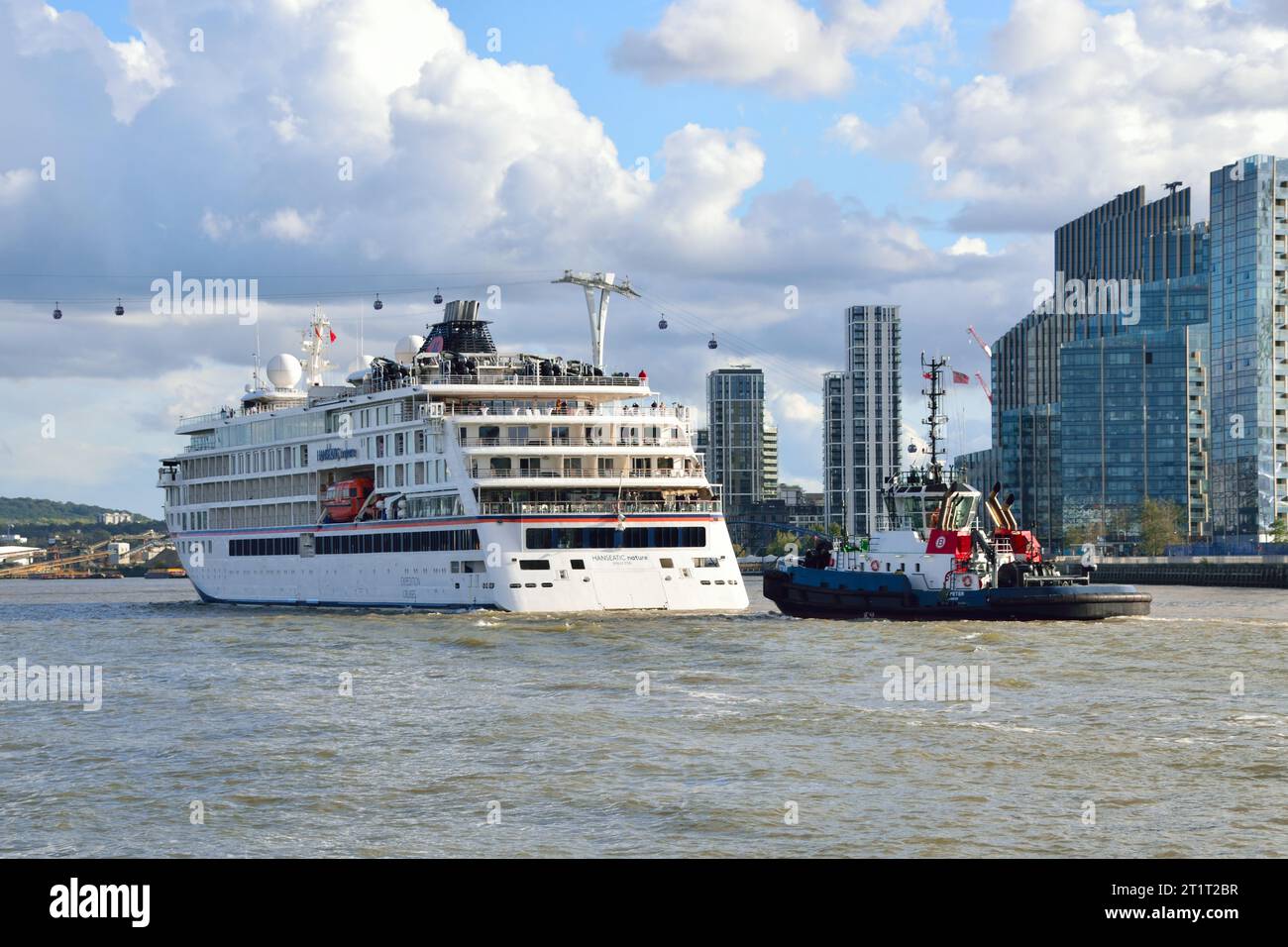 HANSEATIC nature expedition ship operated Hapag-Lloyd Cruises departs down the River Thames after t's maiden port call in London. Stock Photo