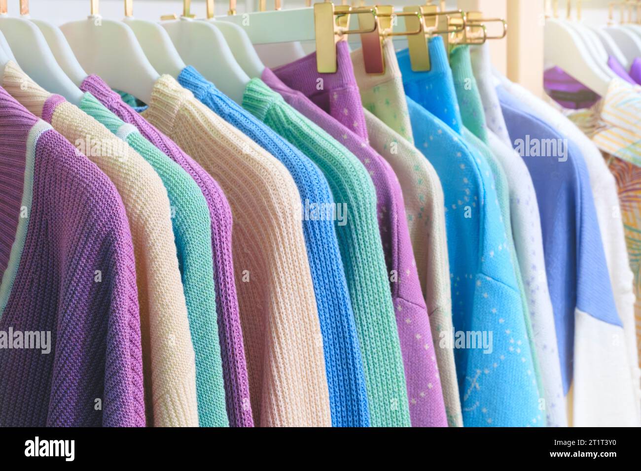 Fashion clothes on clothing rack Closeup of rainbow color choice female ...