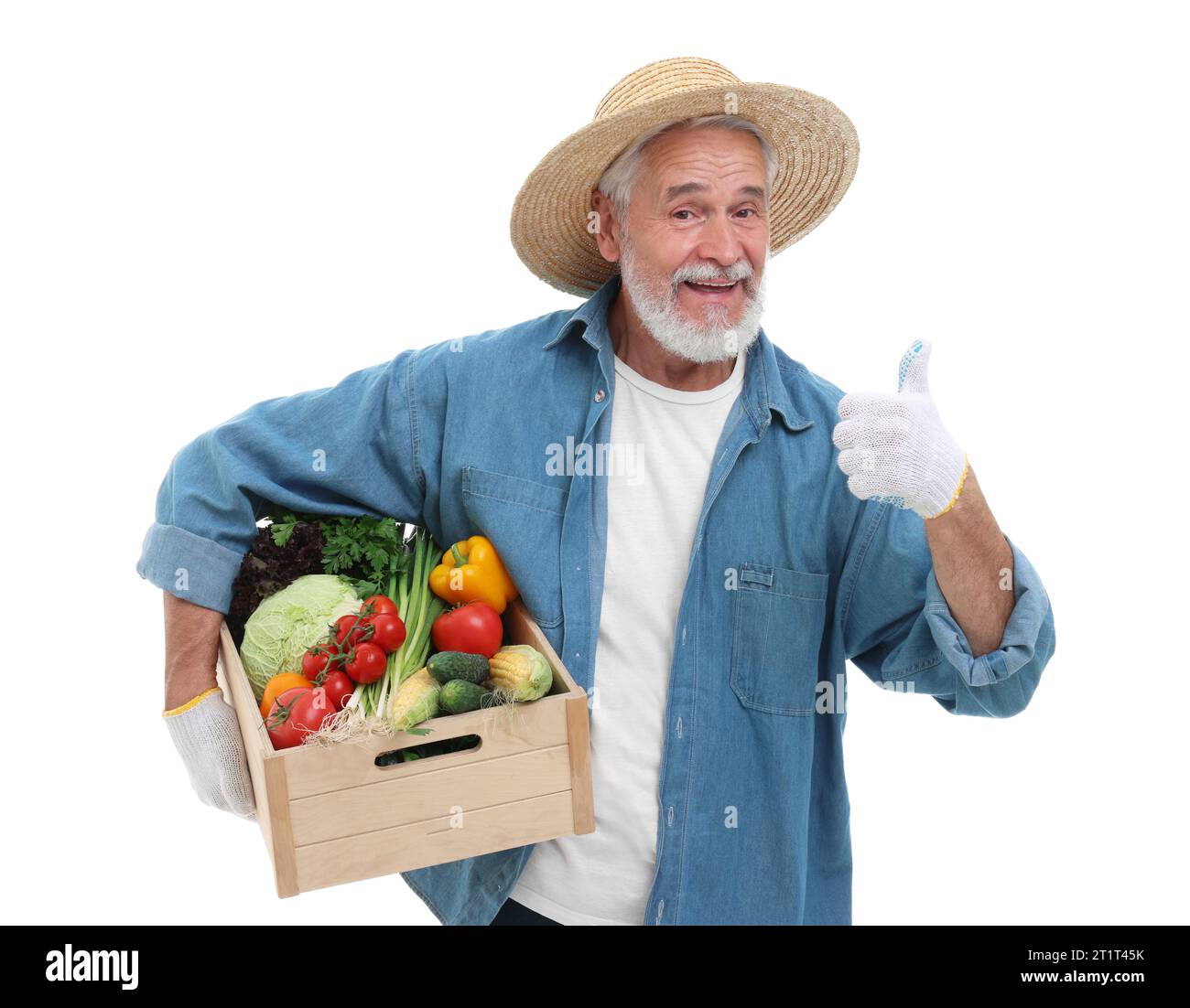 Harvesting season. Happy farmer holding wooden crate with vegetables ...