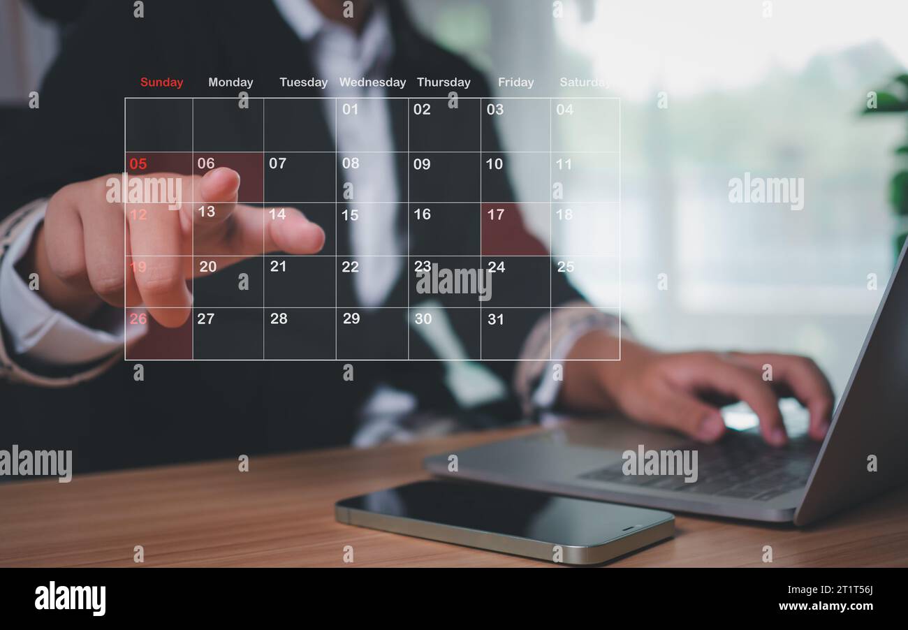 Businesswoman marking dates on virtual calendar, managing his business