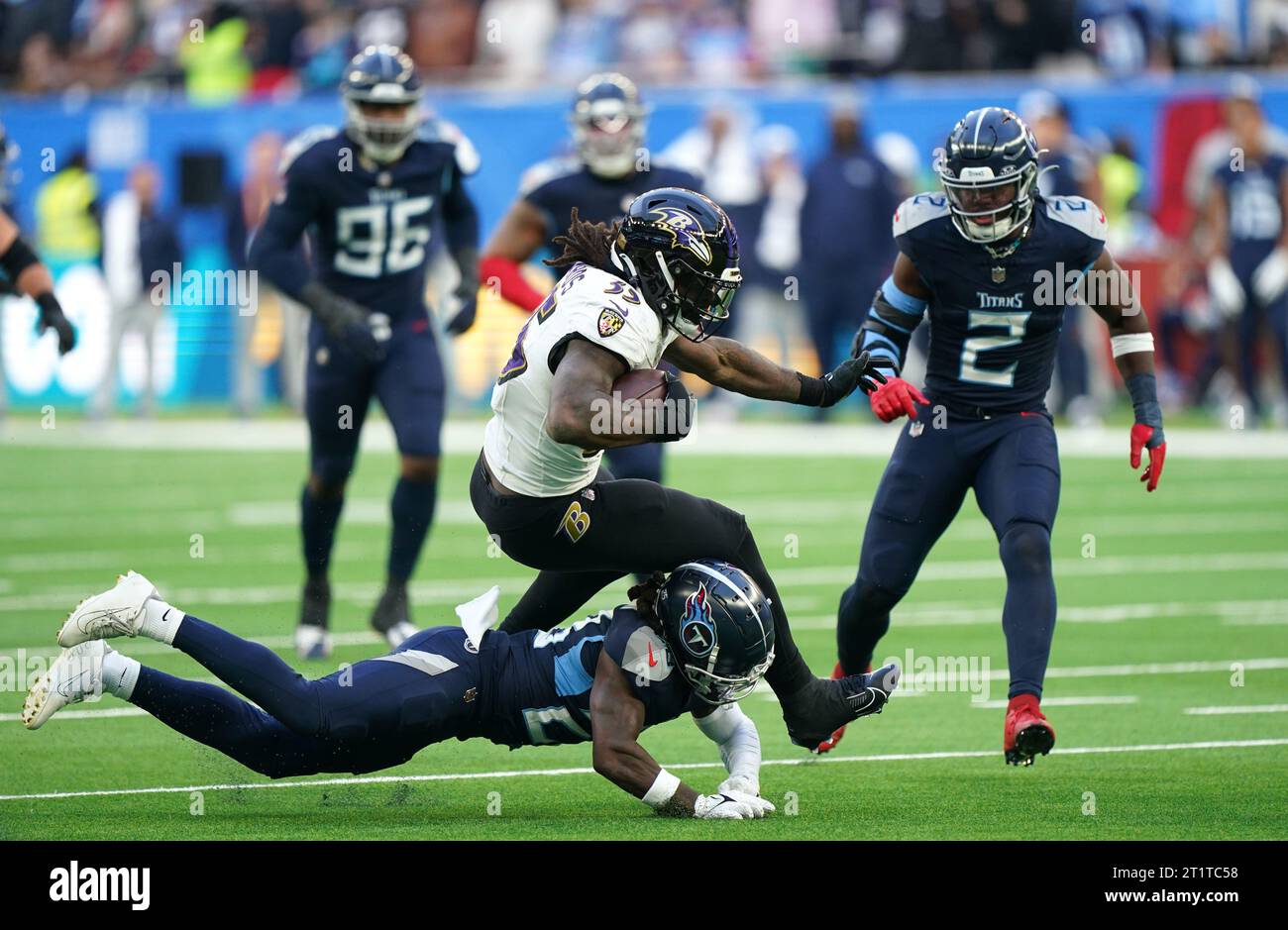 Baltimore Ravens' Gus Edwards is tackled by Tennessee Titans' Shyheim Carter (floor) during the NFL international match at the Tottenham Hotspur Stadium, London. Picture date: Sunday October 15, 2023. Stock Photo
