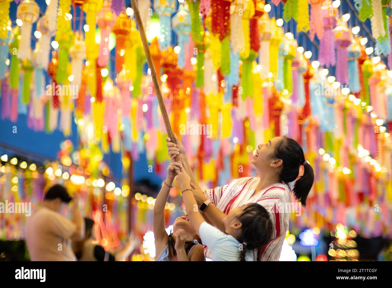 Asian families make wishes and hang lanterns during The Hundred Thousand Lantern Festival or Yi Peng Festival in northern Thailand. Stock Photo