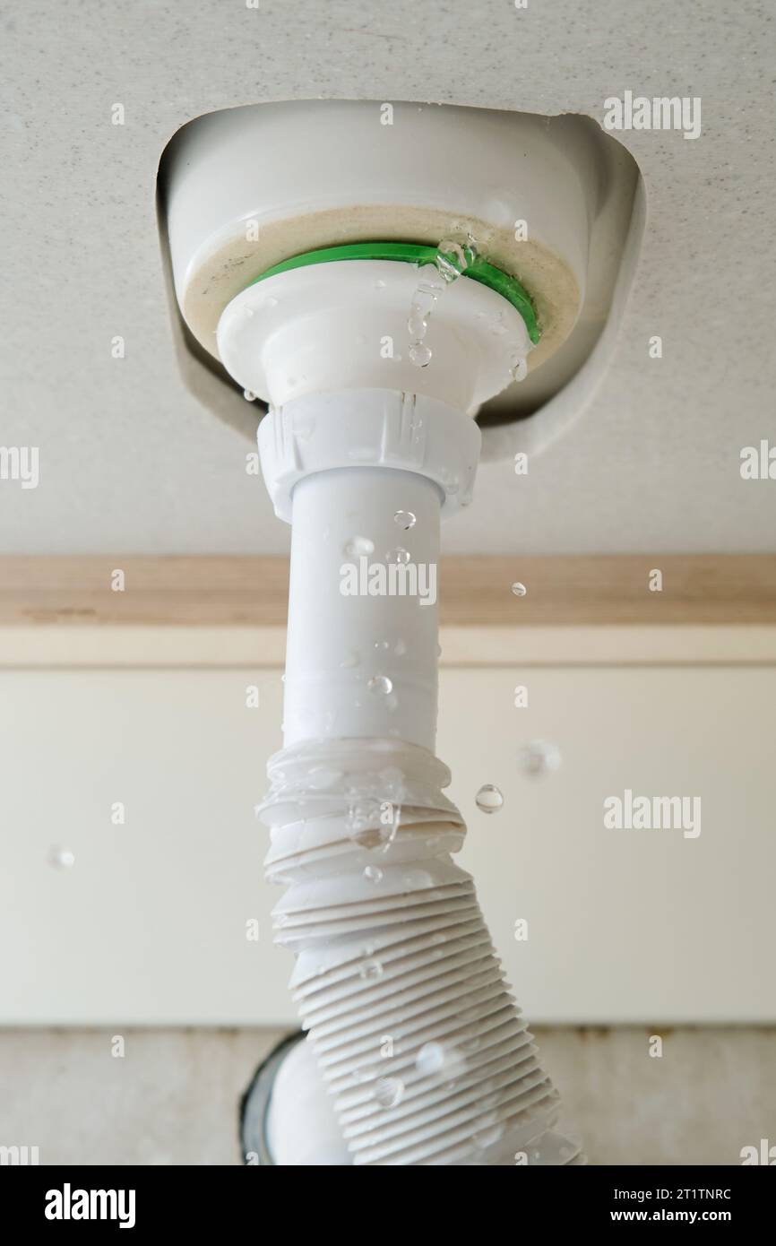 Water leaks at home in the bathroom. Water flows from the pipe under