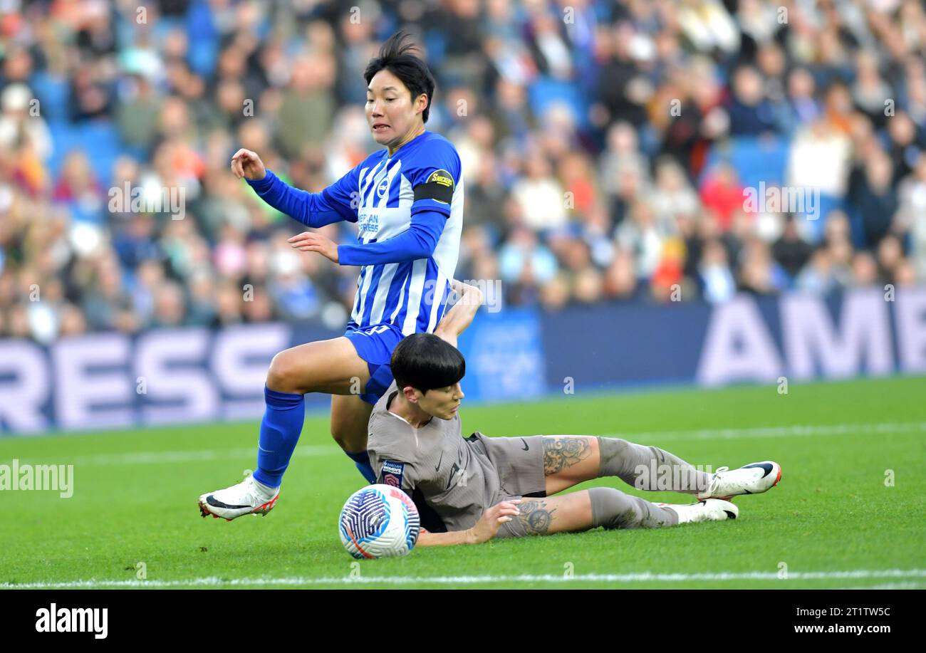 Brighton UK 15th October 2023 -  Geummin Lee of Brighton tangles  Ashleigh Neville of Tottenham with during the Barclays  Women's Super League football match between Brighton & Hove Albion and Tottenham Hotspur at The American Express Stadium (Editorial Use Only) : Credit Simon Dack /TPI/ Alamy Live News Stock Photo