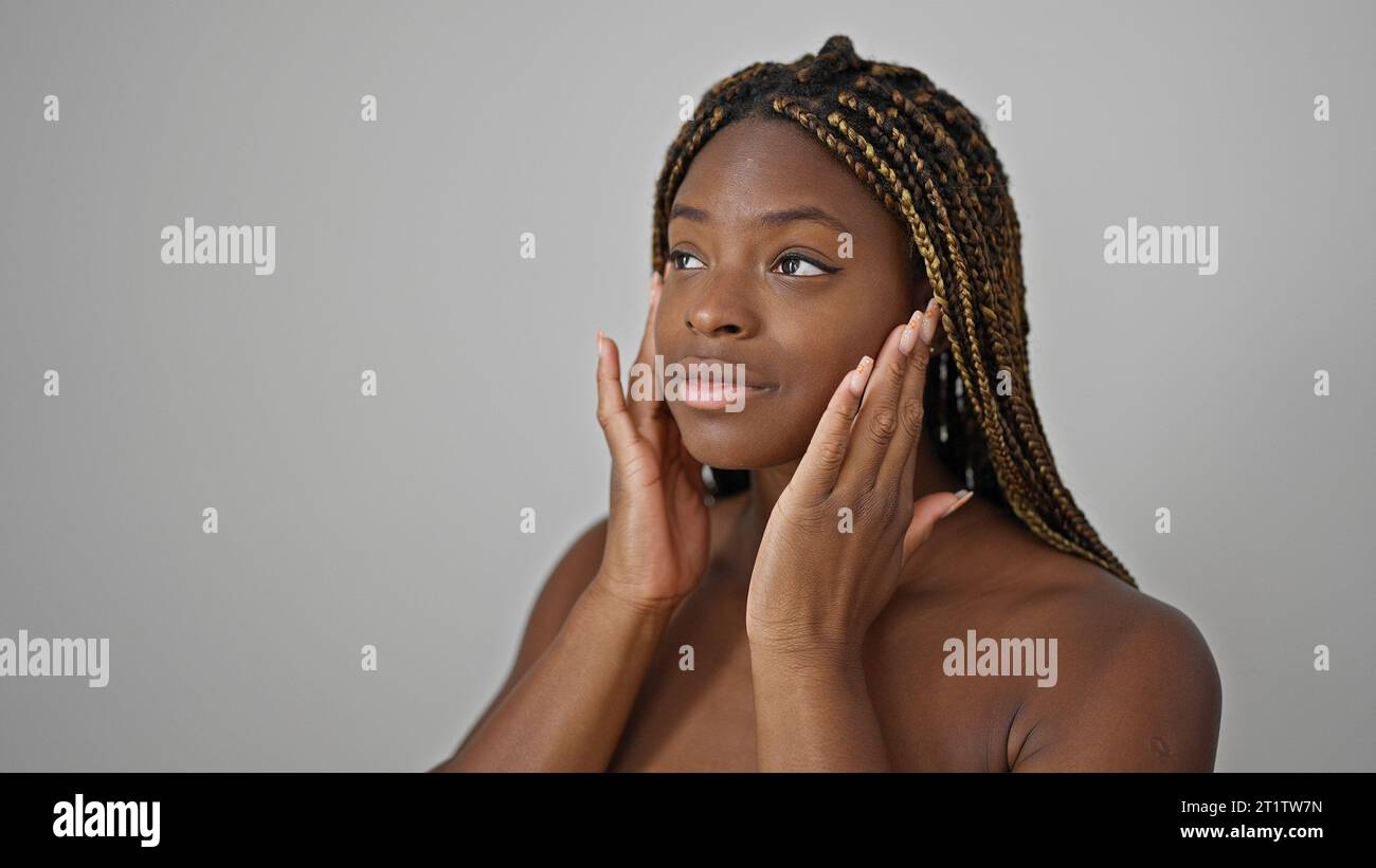 African american woman massaging face over isolated white background ...