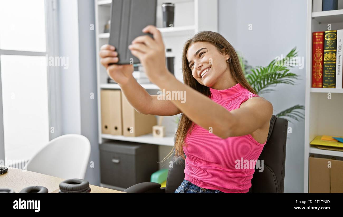 Confident young hispanic business woman grinning while working indoors ...