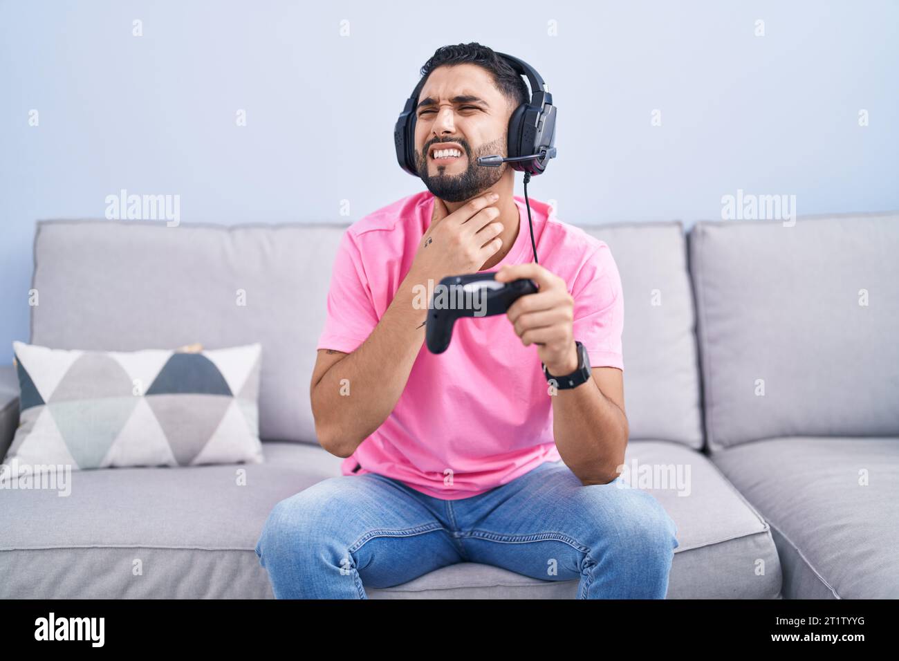Neck Controller Game Hispanic young man playing video game holding controller sitting on the ...