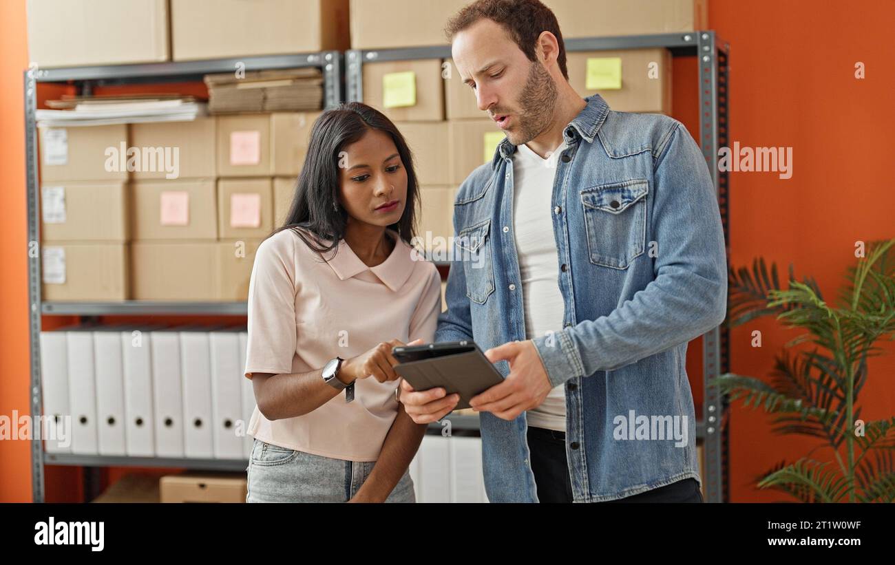 Two workers man and woman using touchpad at office Stock Photo