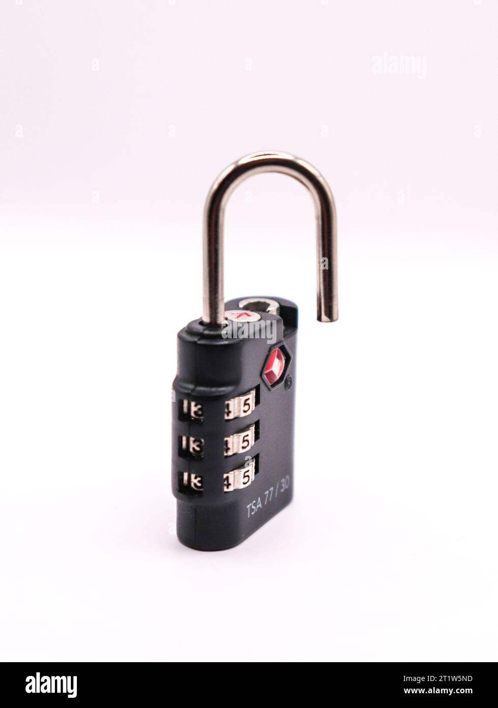 A blacked unlocked lock standing against a black background Stock Photo