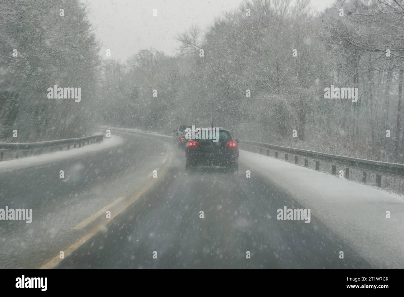 cars on dangerous slippery road in snowy and foggy winter time Stock ...