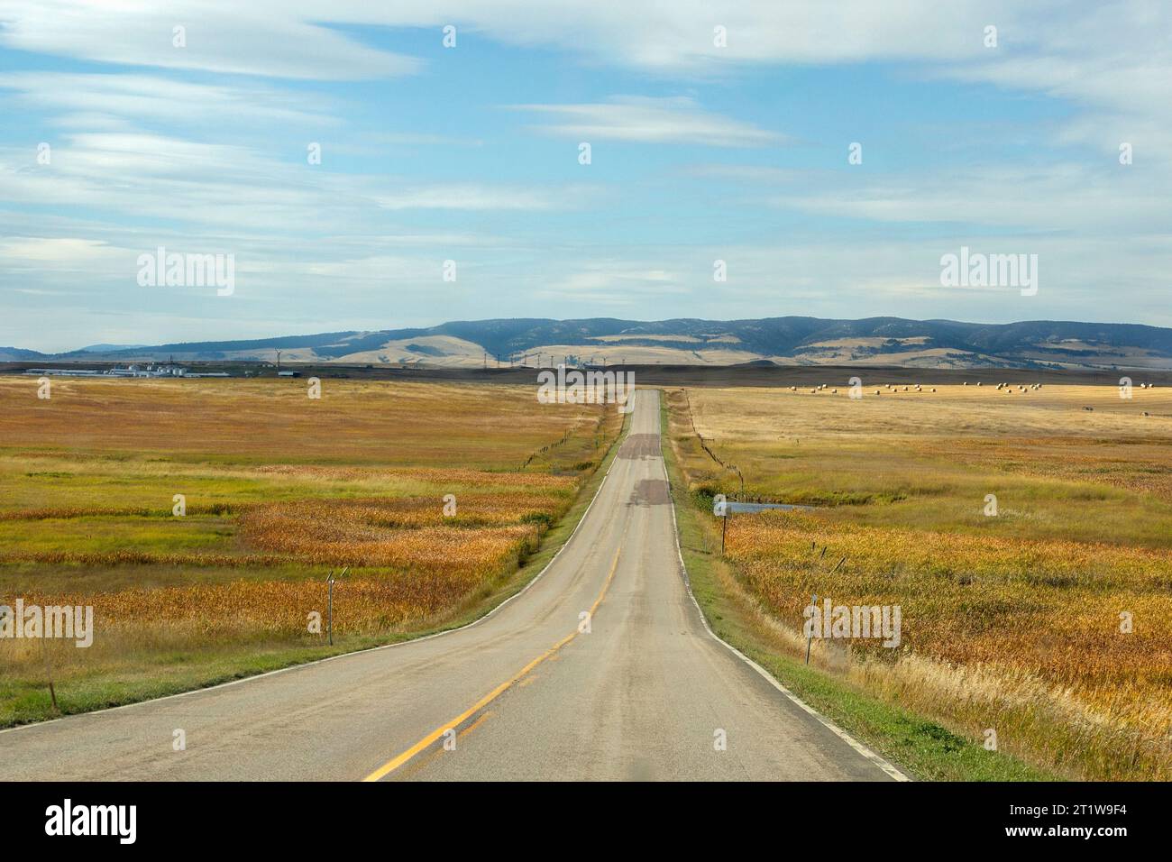 Autumn landscape and two-lane blacktop US Highway 12 near Two Dot, MT in Wheatland County, Montana, USA Stock Photo