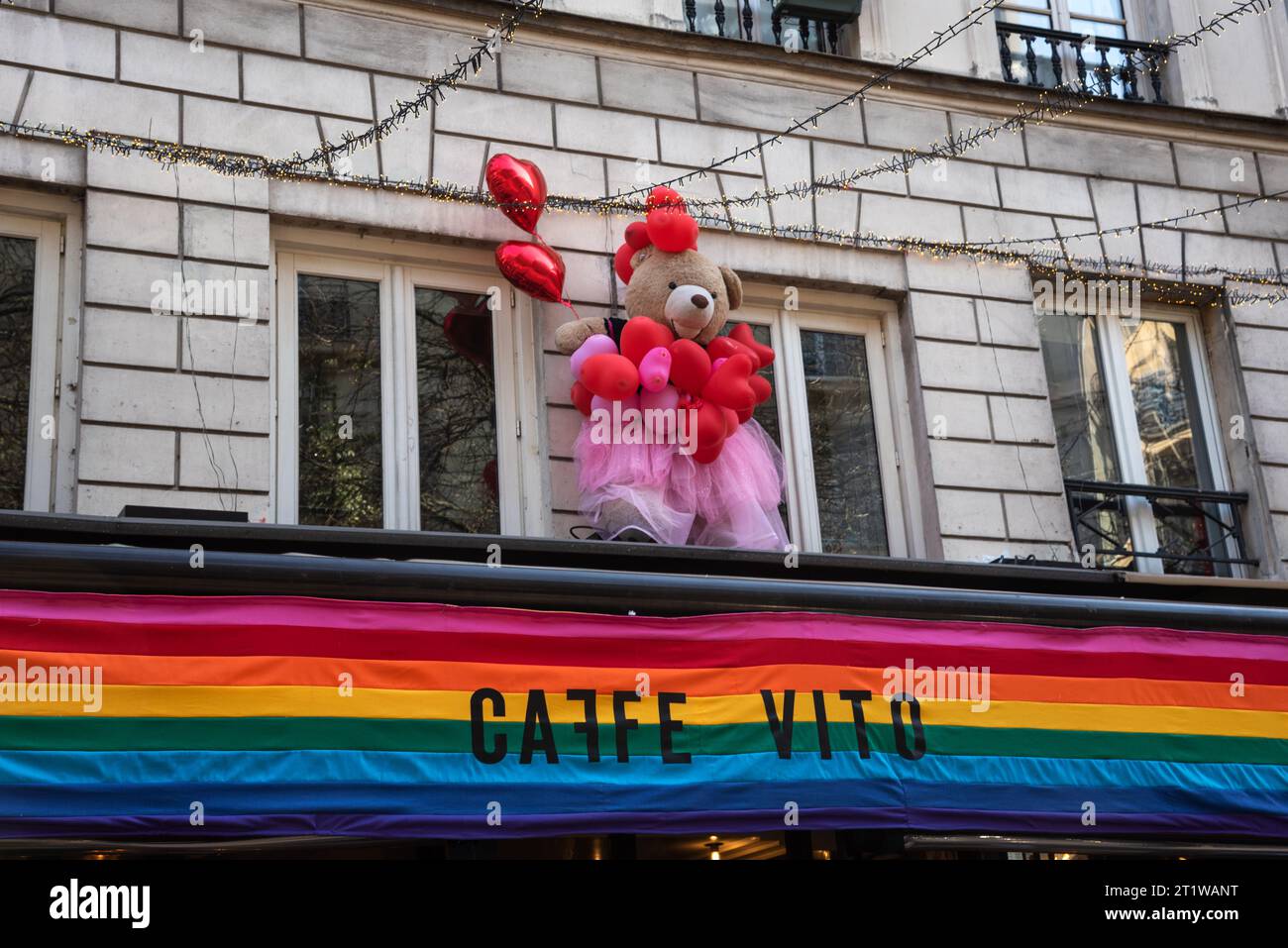 Paris, France - February 21, 2023: After Valentine's Day. Caffe Vito restaurant at Rue des Archives in Marais decorated with teddy bear over lgbt flag Stock Photo