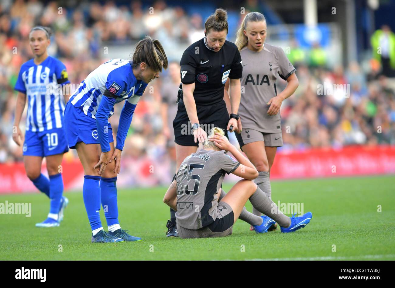Brighton UK 15th October 2023 -  Referee Kirsty Dowle checks on Eveliina Summanen of Tottenham during the Barclays  Women's Super League football match between Brighton & Hove Albion and Tottenham Hotspur at The American Express Stadium (Editorial Use Only) : Credit Simon Dack /TPI/ Alamy Live News Stock Photo