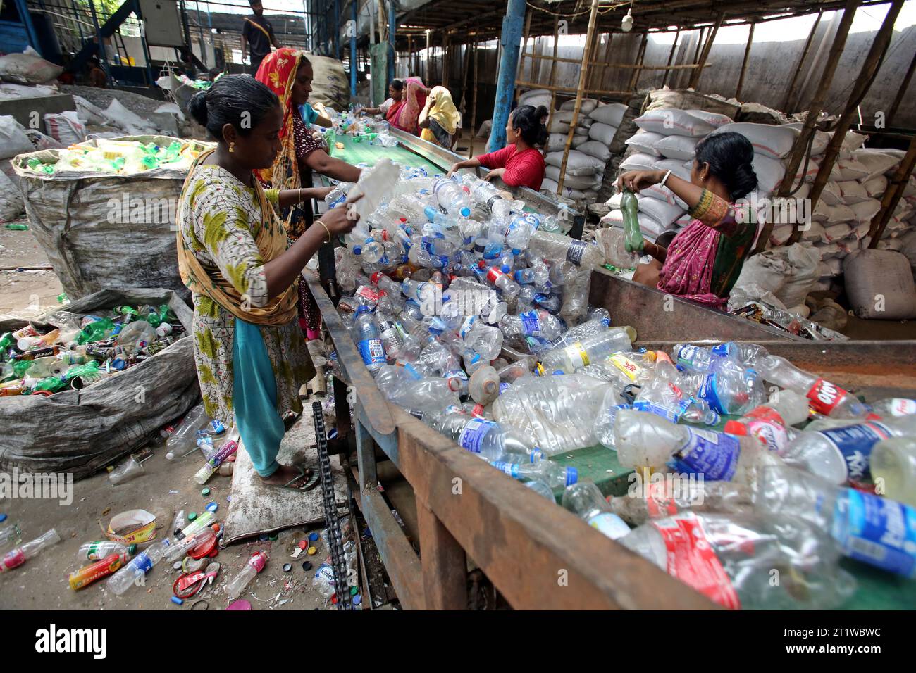 Dhaka, Bangladesh. 15th Oct, 2023. Employees recycling empty pet bottles to be reused again in a