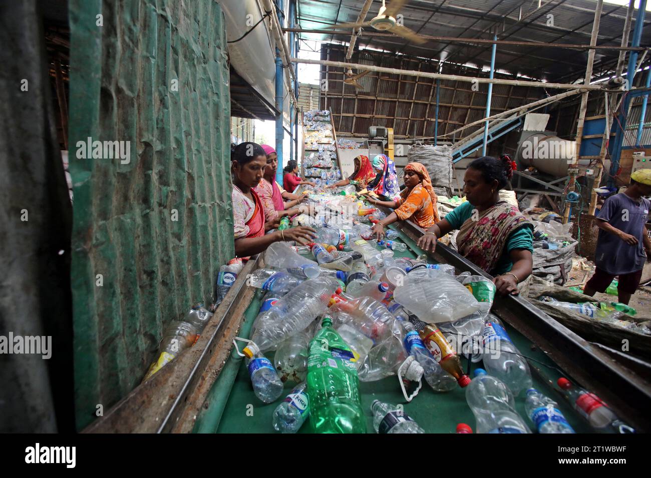 Dhaka, Bangladesh. 15th Oct, 2023. Employees recycling empty pet bottles to be reused again in a