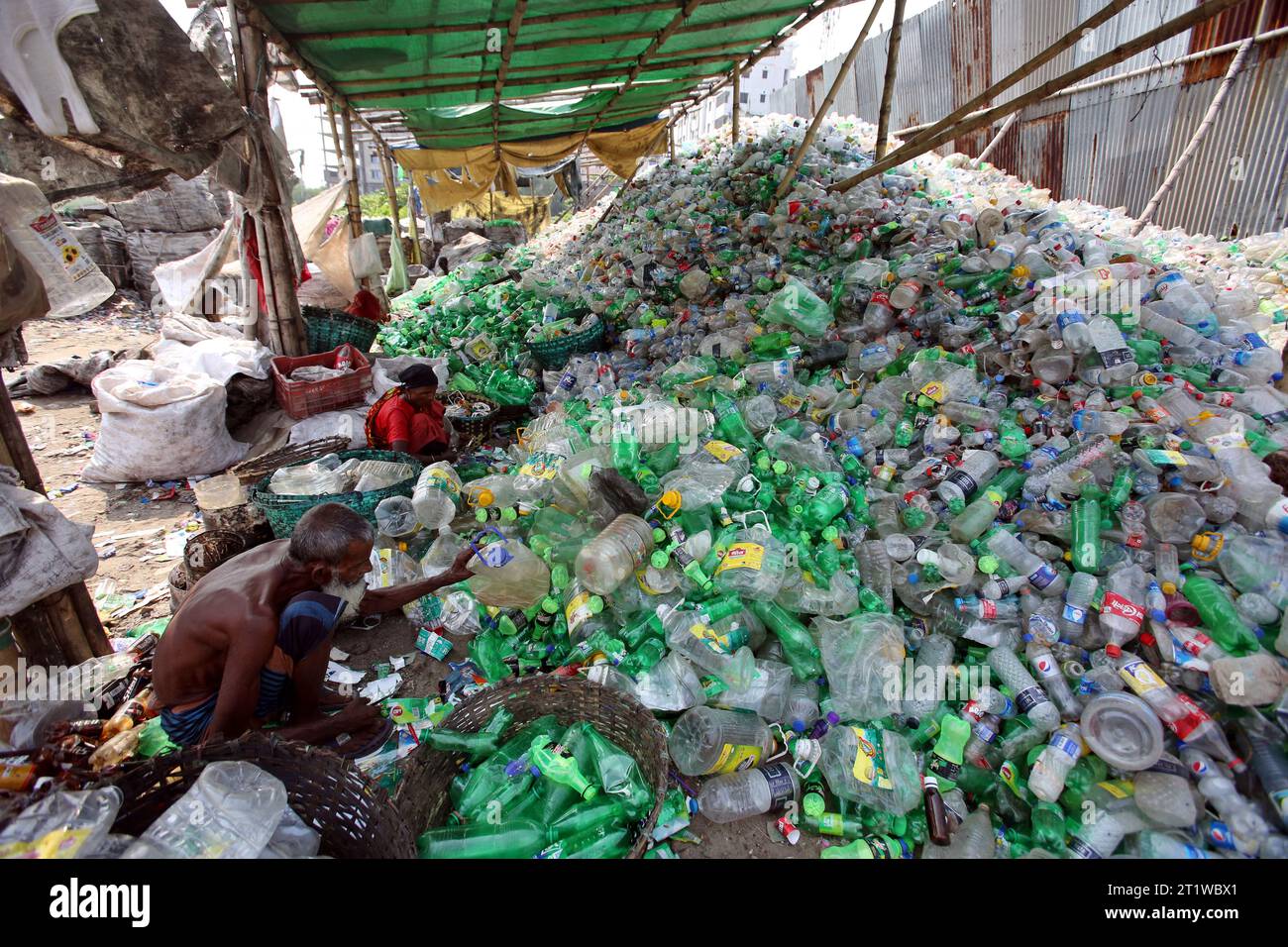 Dhaka, Bangladesh. 15th Oct, 2023. Employees recycling empty pet