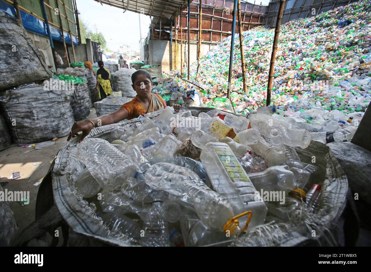 Dhaka, Bangladesh. 15th Oct, 2023. Employees recycling empty pet