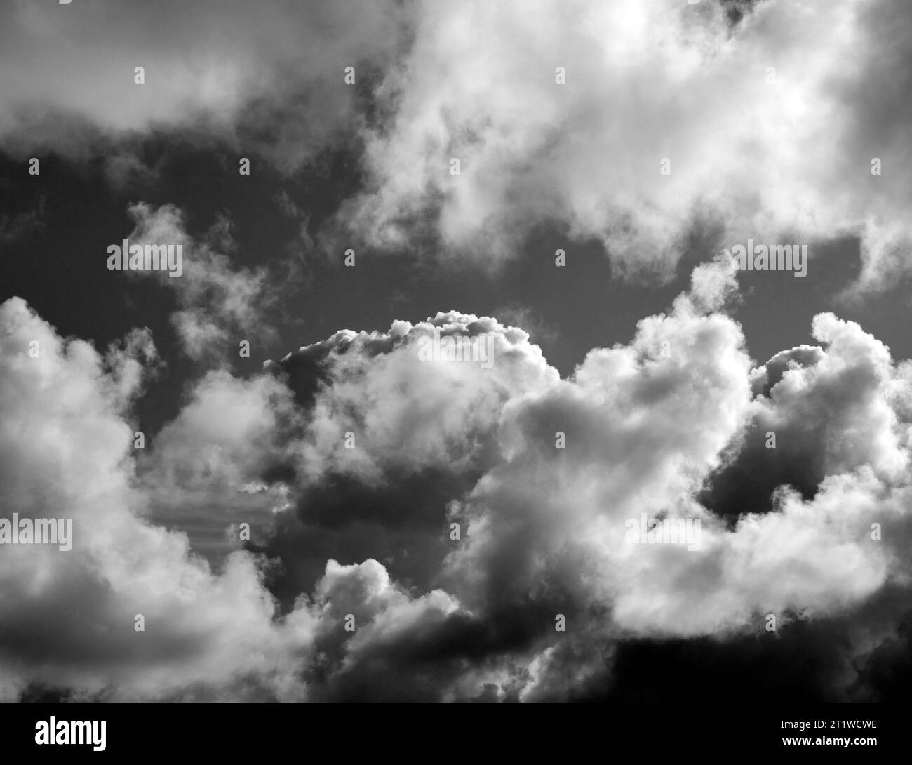 Black and White Beautiful sky with fluffy white clouds over modern city ...