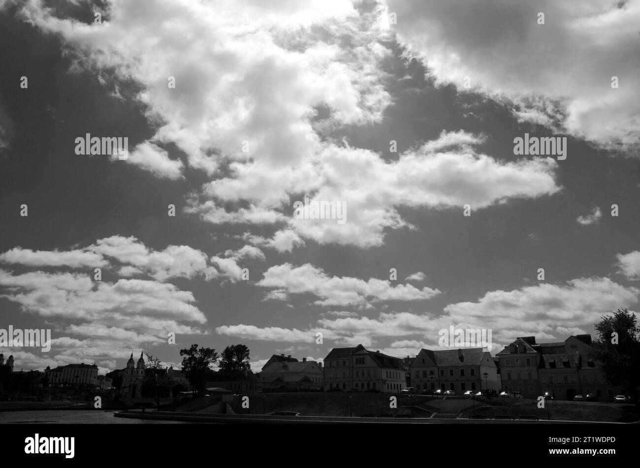Black and White Beautiful sky with fluffy white clouds over modern city ...