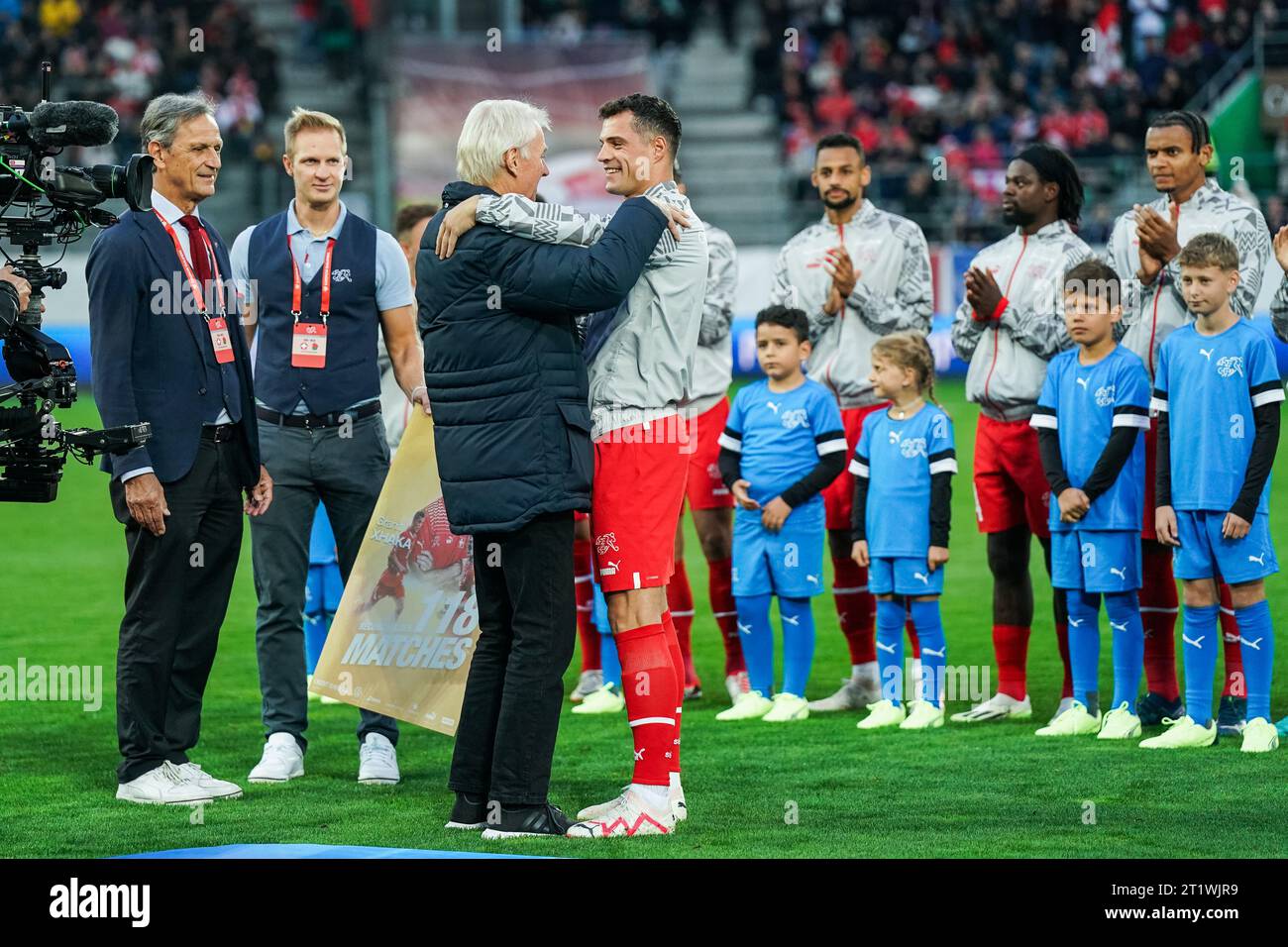 St. Gallen, St. Gallen. 15th Oct, 2023. St. Gallen, Switzerland, October 15th 2023: Heinz Hermann - former Switzerland player and record holder of 118 game appereances - congratulages Granit Xhaka (10 Switzerland) during the UEFA European Qualifiers football match between Switzerland and Belarus at Kybunpark in St. Gallen, Switzerland. (Daniela Porcelli/SPP) Credit: SPP Sport Press Photo. /Alamy Live News Stock Photo