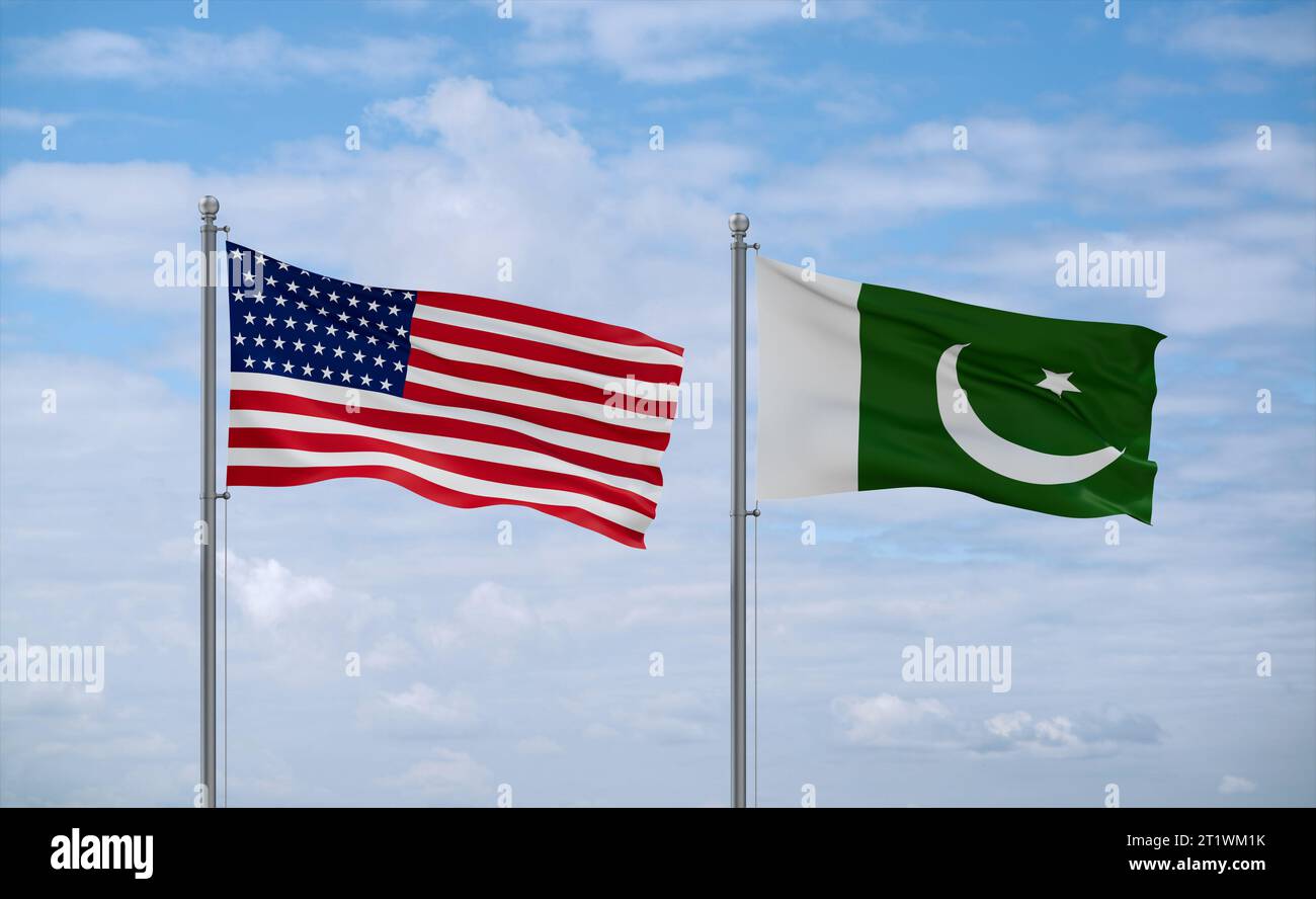 Pakistan and USA flags waving together on blue cloudy sky, two country relationship concept Stock Photo