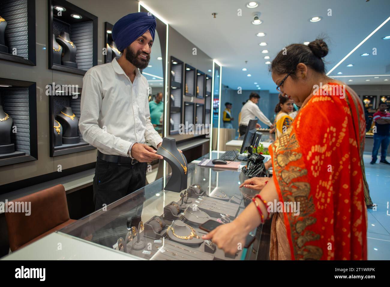 New Delhi, India. 15th Oct, 2023. Customers buy jewelry at the newly open Kalyan jewelers showroom at Karol Bagh, New Delhi. Kalyan Jewelers is an Indian chain of jewelry showrooms. It was founded by T. S. Kalyanaraman in 1993. Credit: SOPA Images Limited/Alamy Live News Stock Photo