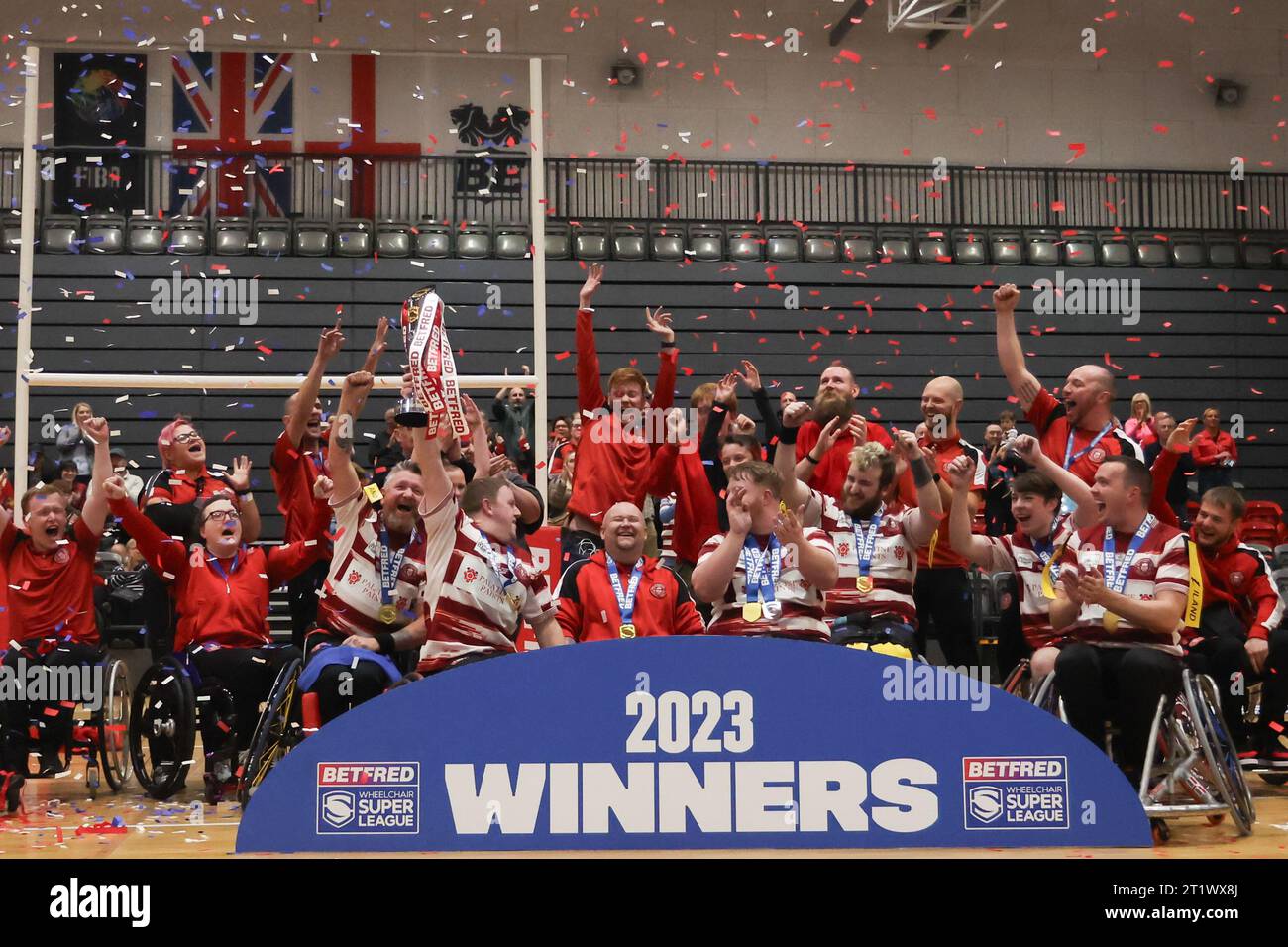 Manchester, UK. 15th Oct, 2023. National Basketball Centre, Belle Vue Arena, Kirkmanshulme Ln, Manchester, 14th October 2023. Betfred Wheelchair Super League Grand Final Leeds Rhinos v Wigan Warriors Wigan celebrate with the Wheelchair Super League trophy. Credit: Touchlinepics/Alamy Live News Stock Photo