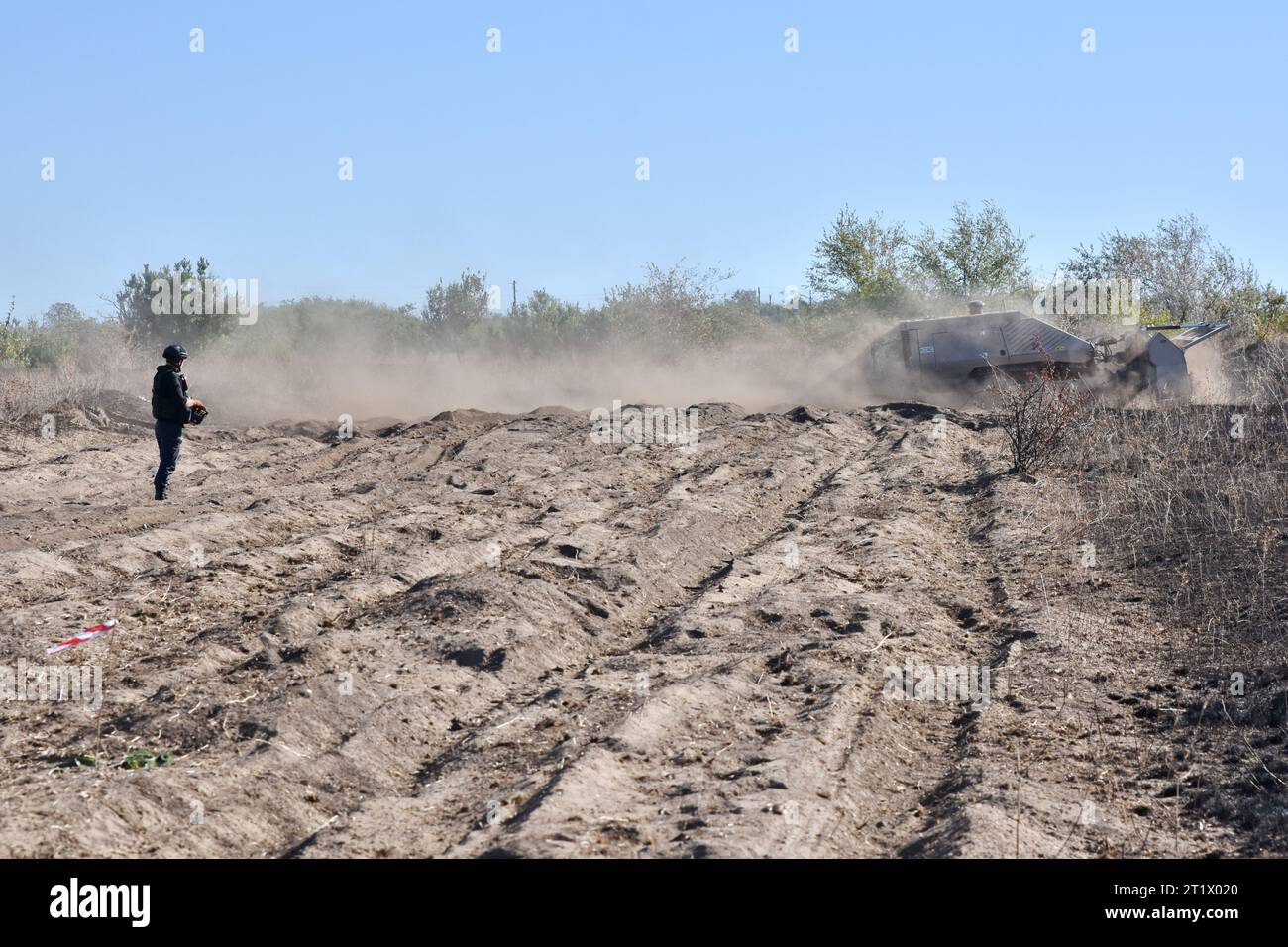 A Ukrainian sapper operates the unmanned demining vehicle during the demining operation in Velyka Oleksandrivka. In March 2022, Velyka Oleksandrivka was occupied by Russian forces. On 4 October 2022, Ukrainian authorities regained control of the settlement during the Southern counteroffensive. War-battered northern Kyiv, Sumy, Chernihiv, southern Mykolaiv, Zaporizhzhia, Kherson, and eastern Kharkiv, Luhansk, and Donetsk regions are the most mined, according to Ukraine's State Emergency Service. It takes at least ten years to clear these areas. Stock Photo