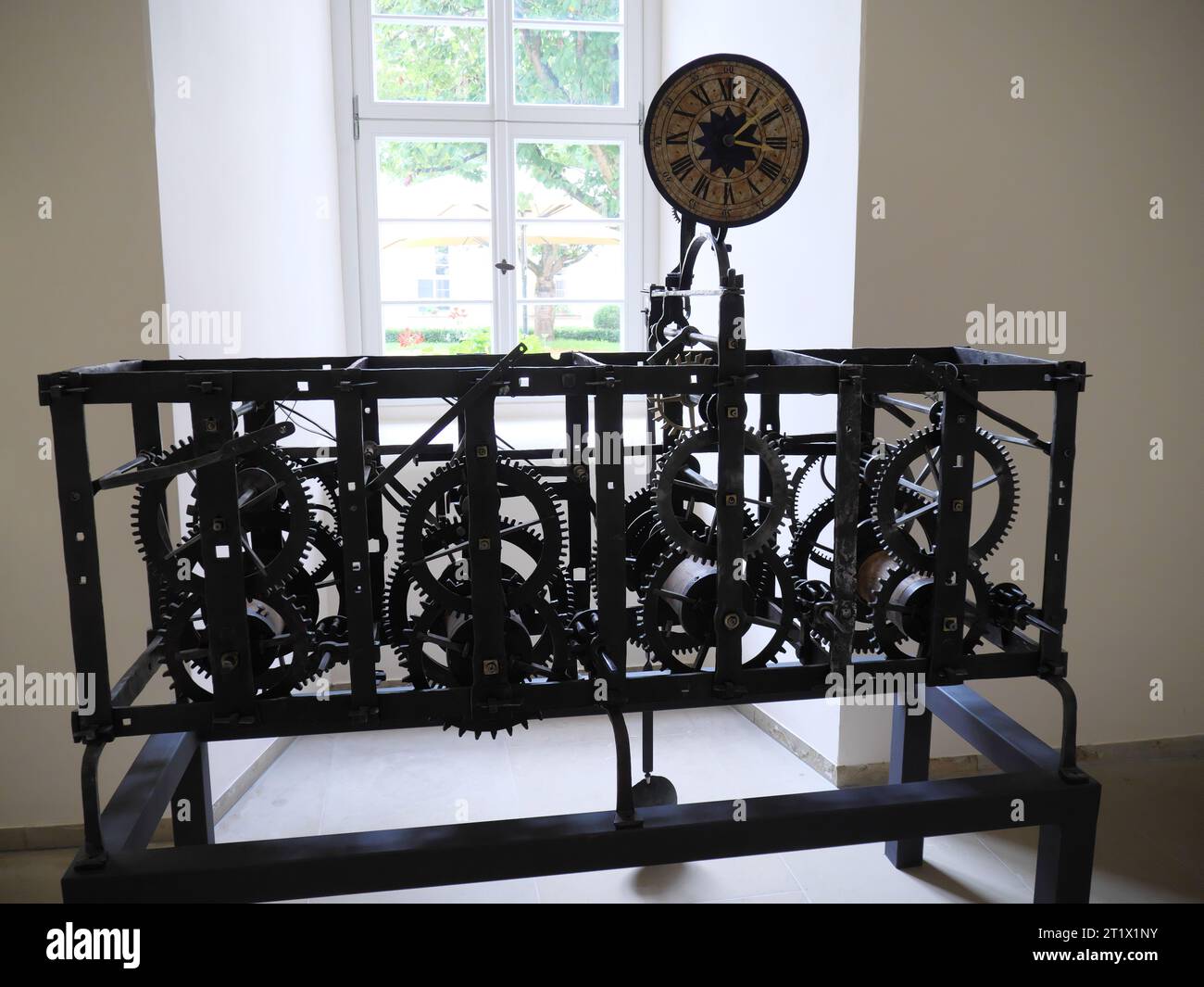 Historical clockwork with gears and dial in the cloister of the