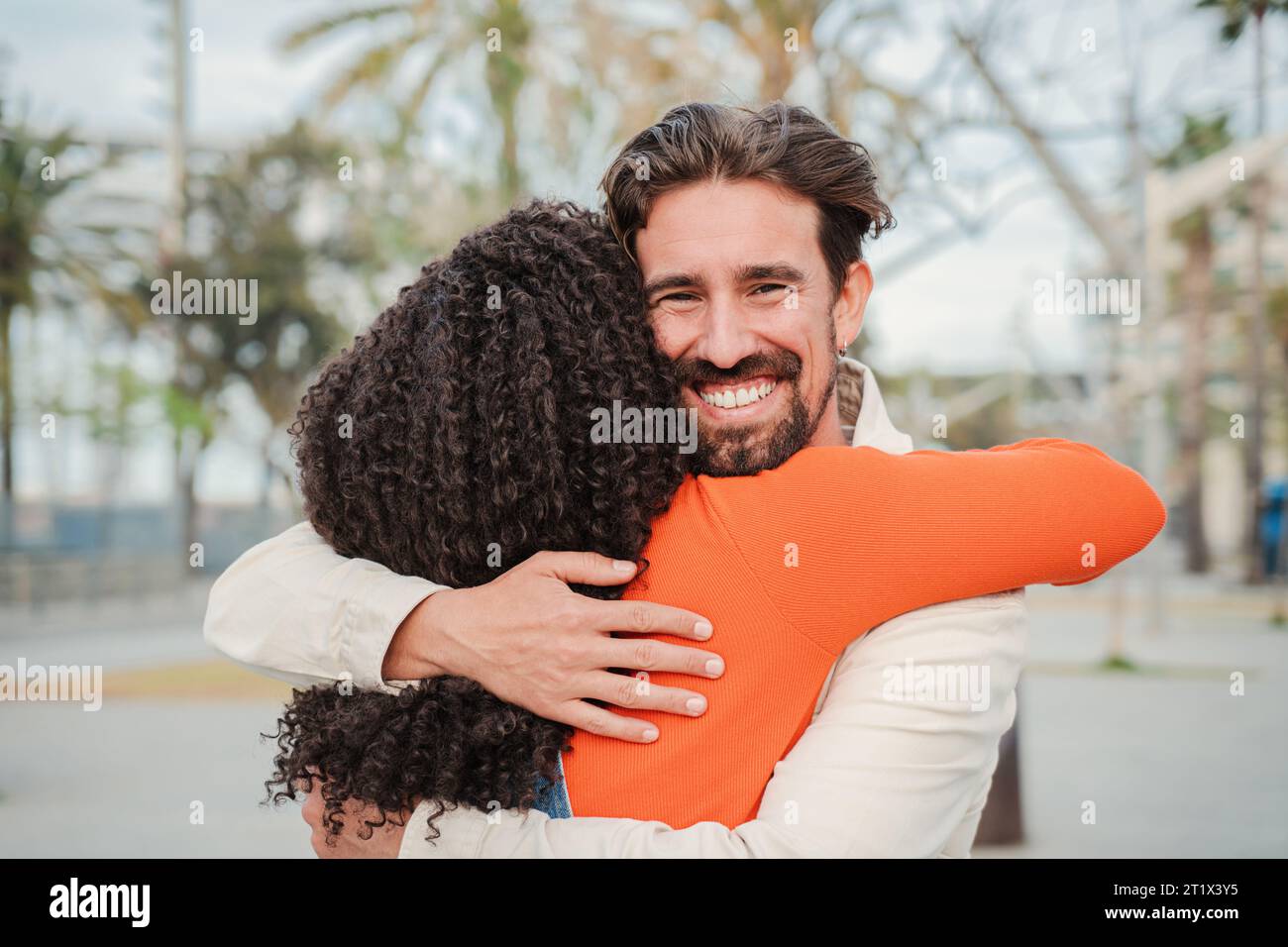 Happy multiracial couple embracing walking hi-res stock photography and ...