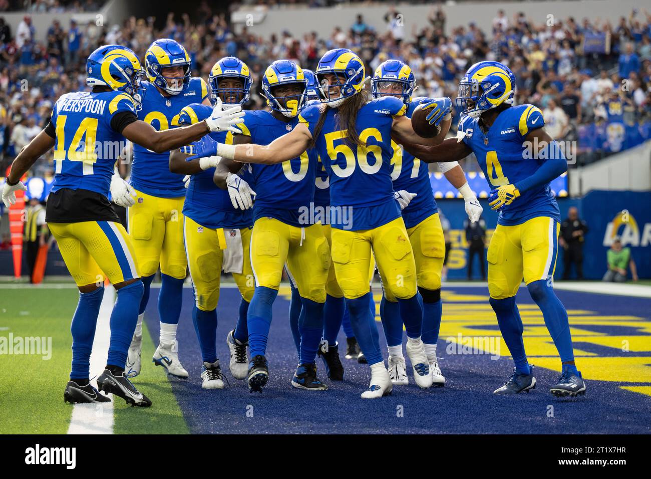 Los Angeles Rams players celebrate an interception by linebacker Christian Rozeboom (56) during