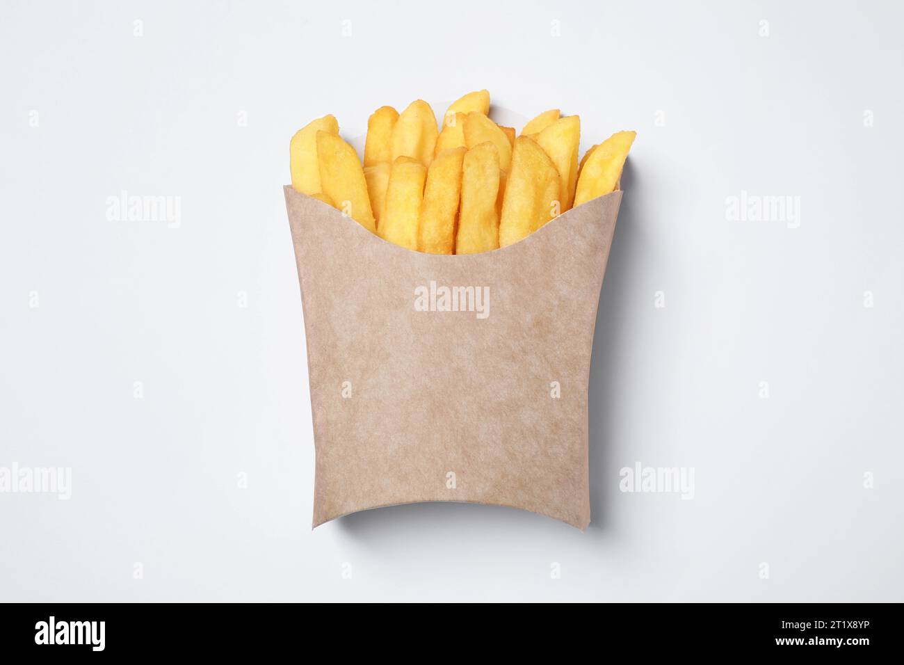 Paper cup with French fries on white table, top view Stock Photo - Alamy