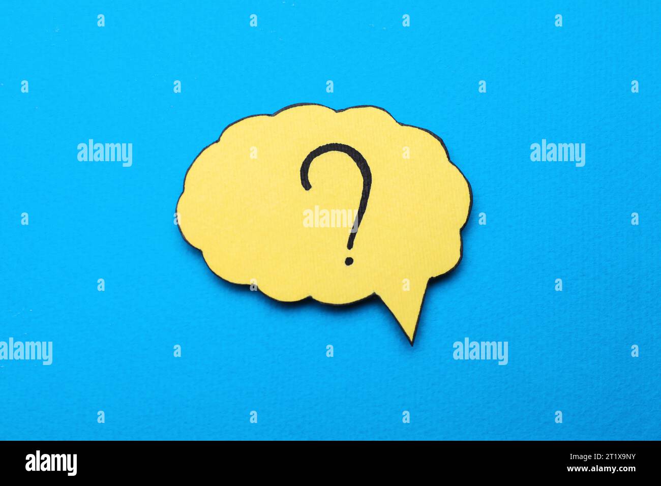 Paper speech bubble with question mark on light blue background, top view Stock Photo