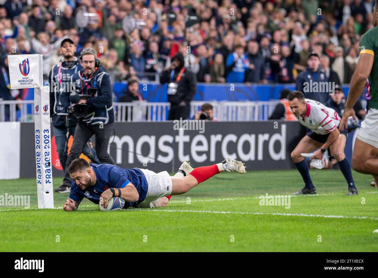 France's loosehead prop Cyril Baille dives across the line to score