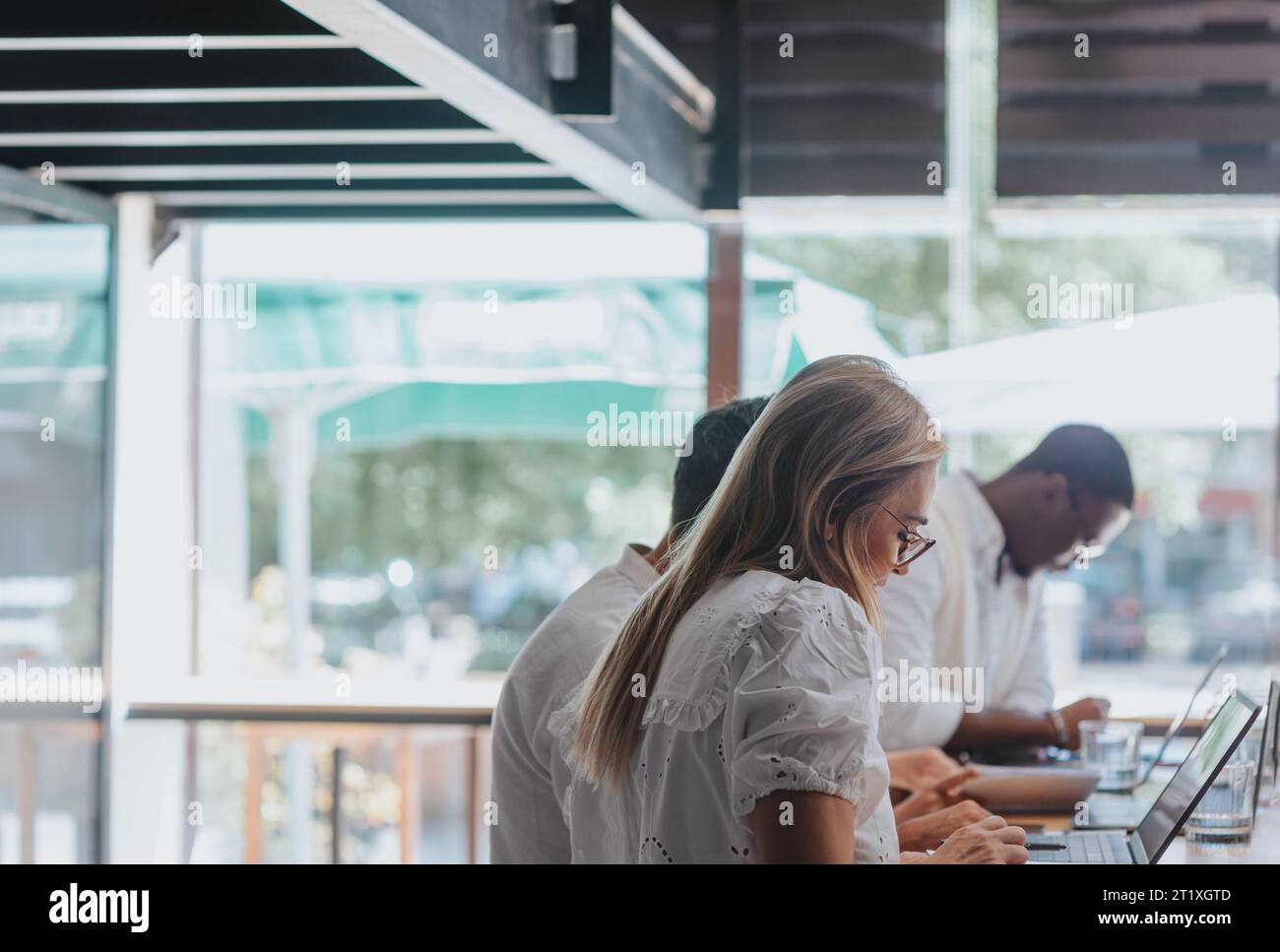 Diverse, efficient team in a creative office. Analyzing reports, planning projects, and using technology for successful business growth. Stock Photo